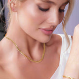 Close-up of a woman wearing a Vermeil Curb Chain with a radiant, warm luster, showcasing its elegant design.