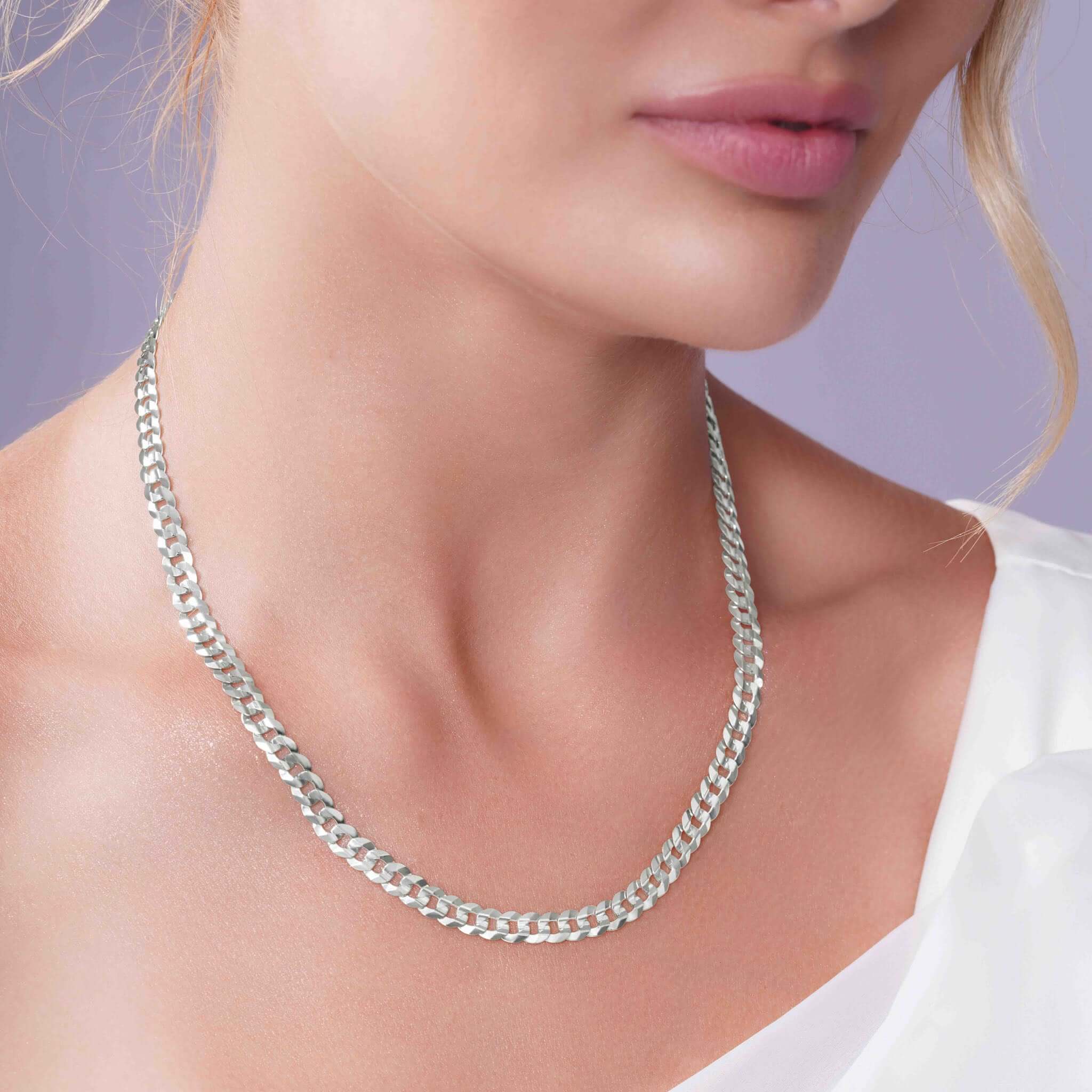 Curb Silver Chain displayed on a model, showcasing its elegant design and durable silver links.