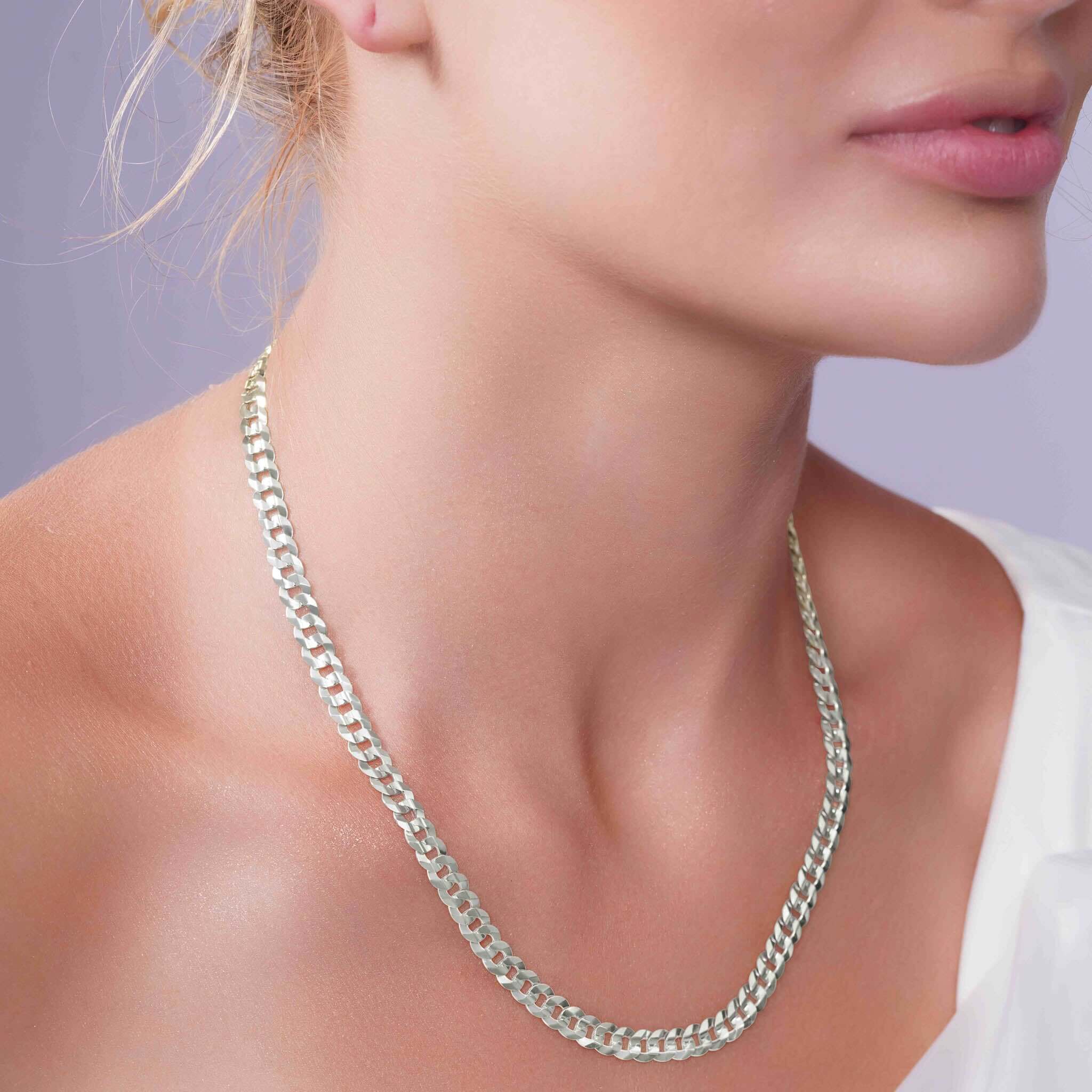 Curb Silver Chain worn by a woman, showcasing its elegant design and sophisticated appeal.
