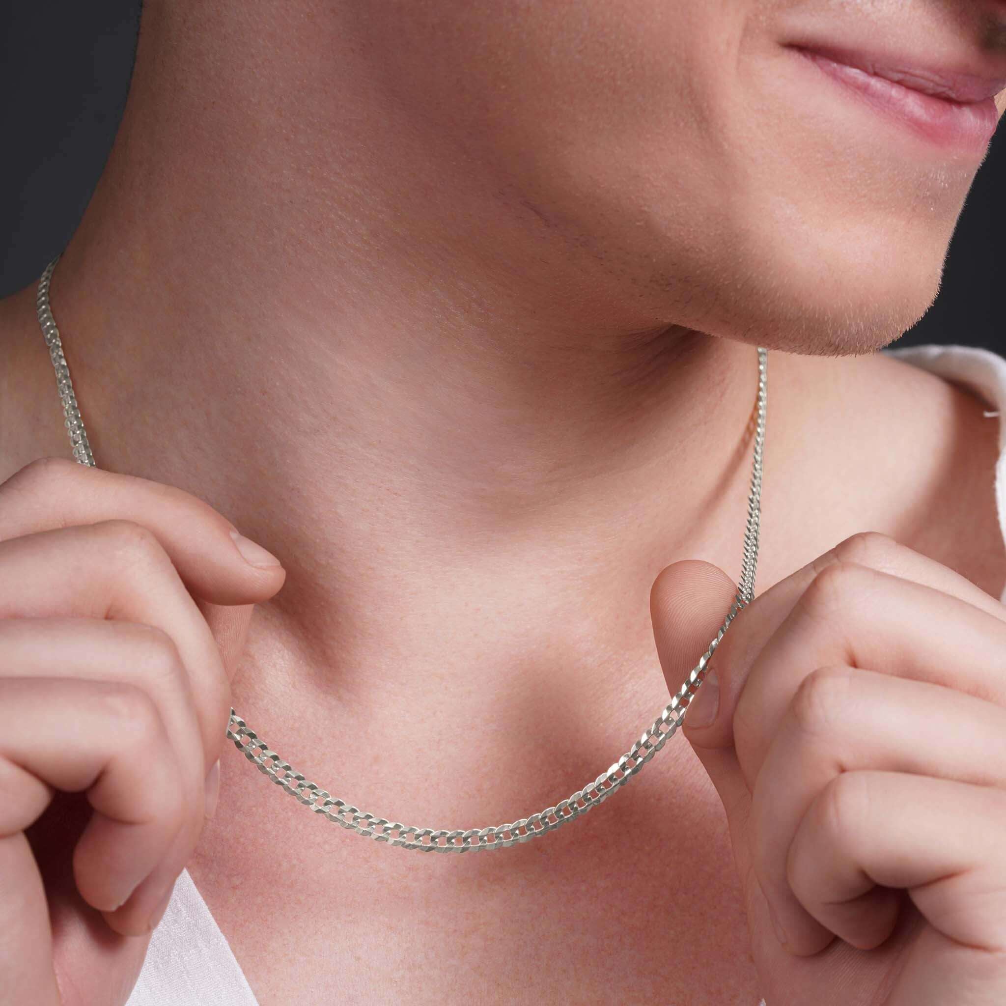Men's Curb Silver Chain worn by a man showcasing its sleek and polished look.