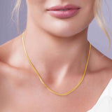 Vermeil Miami Cuban Chain worn elegantly, showcasing its thick interlocking design and rich golden glow.