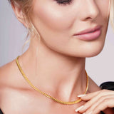 Beautiful woman wearing Vermeil Miami Cuban Chain, showcasing its luxurious gold glow and elegant design.
