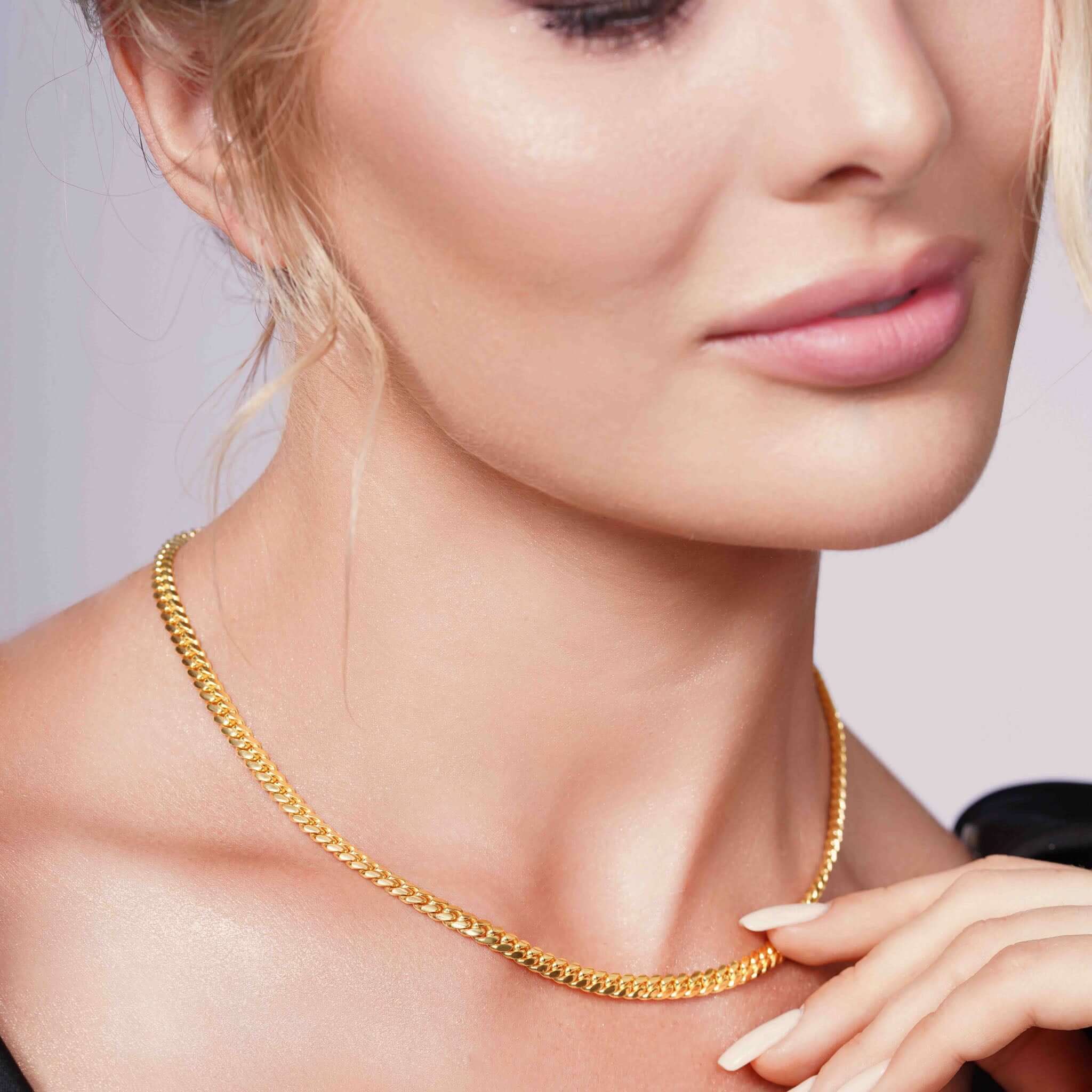 Beautiful woman wearing Vermeil Miami Cuban Chain, showcasing its luxurious gold glow and elegant design.