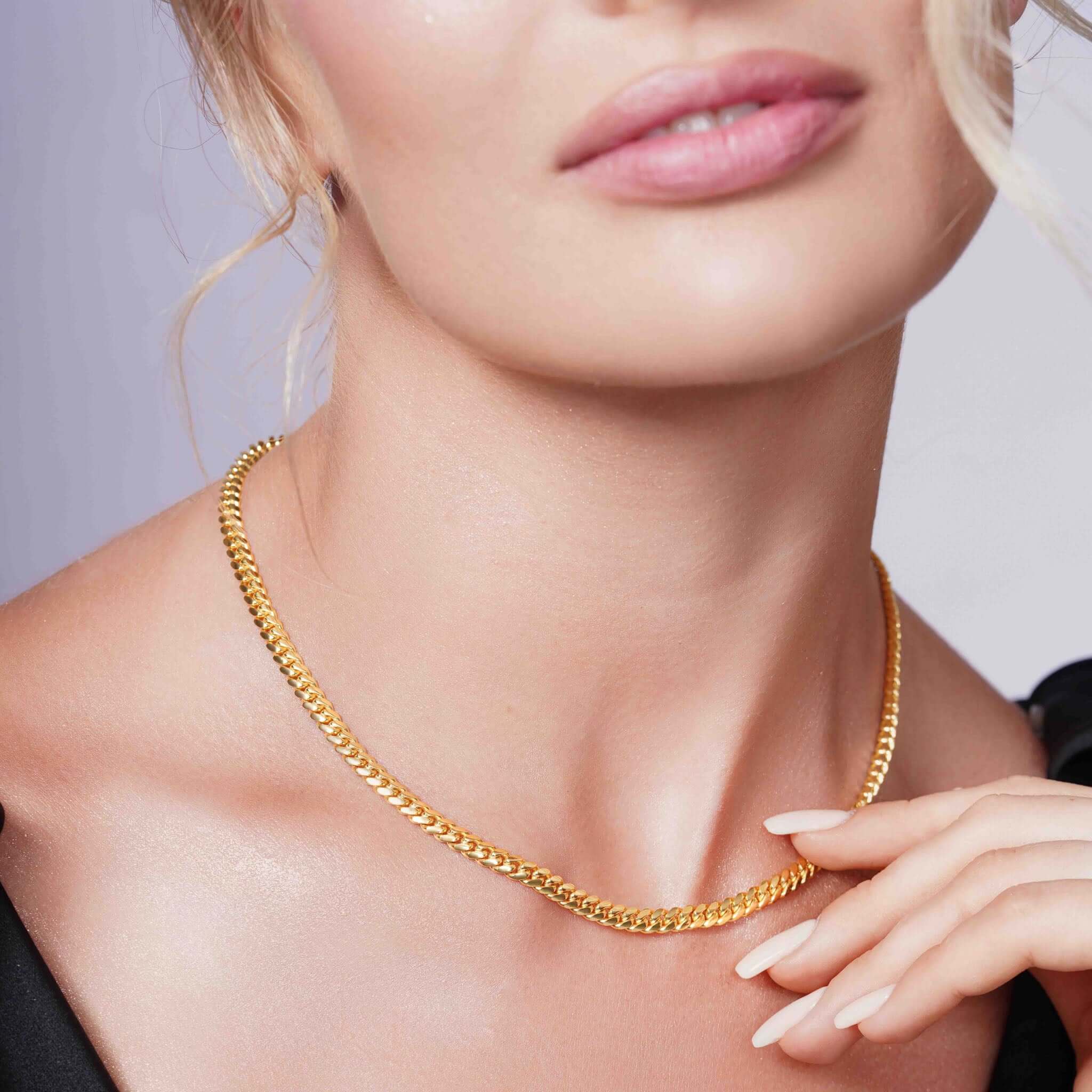 Vermeil Miami Cuban Chain elegantly displayed on model's neck, showcasing its lustrous gold design and refined appearance.
