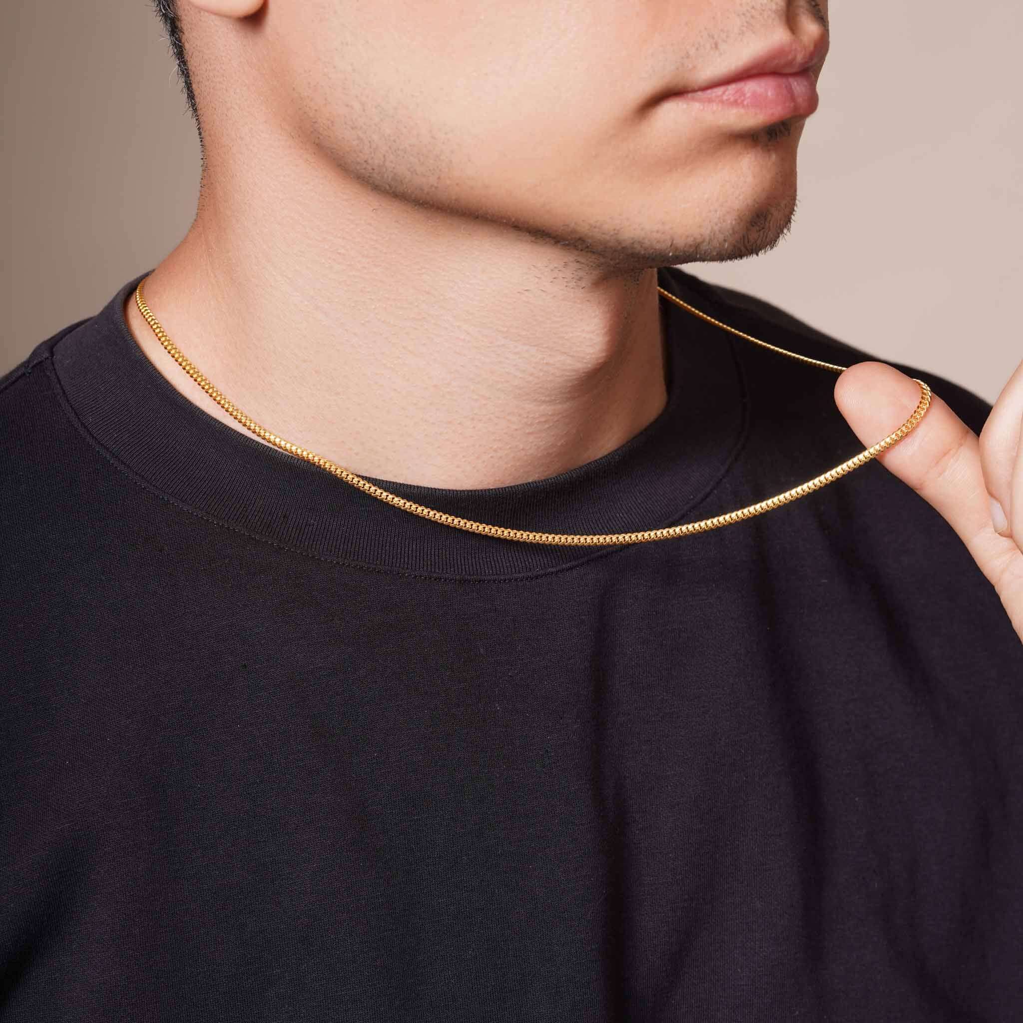 Men's Vermeil Miami Cuban Chain worn by a man, showcasing its classic design and luxurious gold vermeil finish.