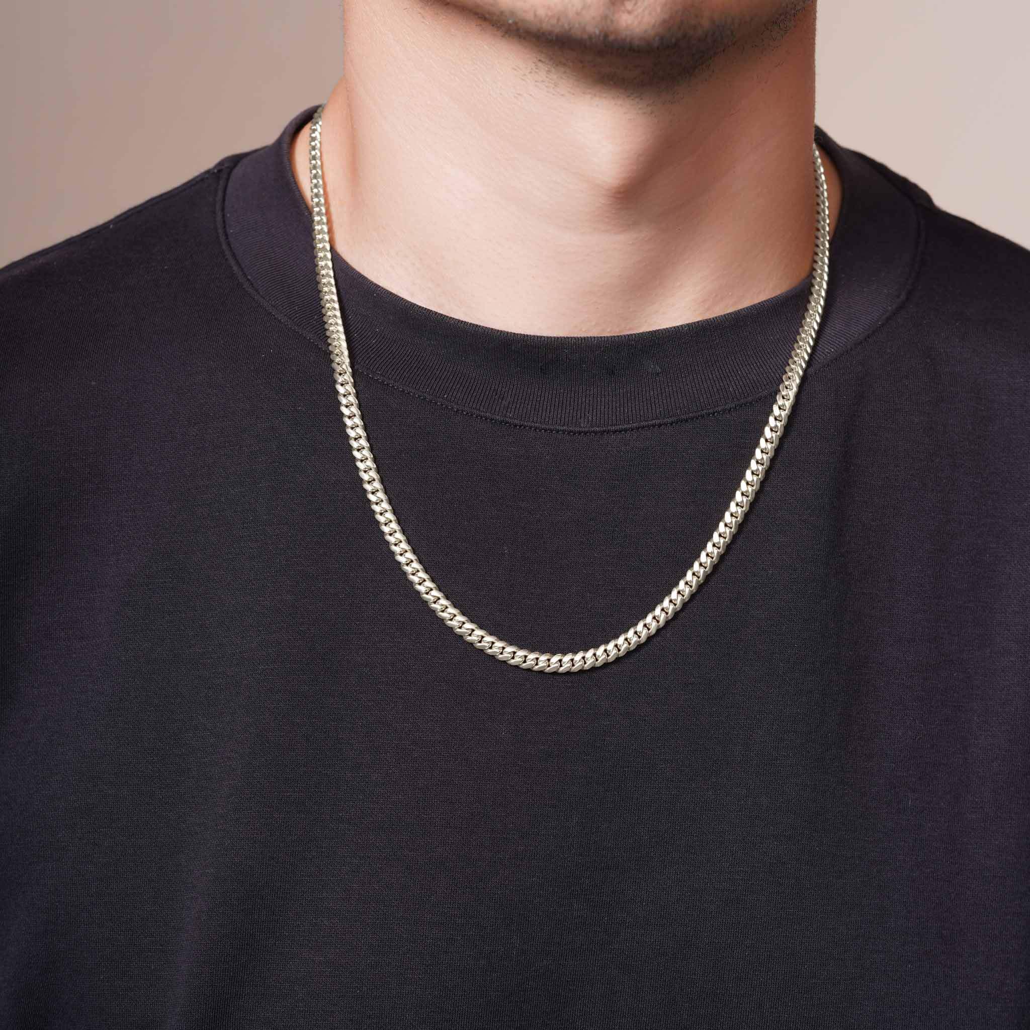Men's Silver Miami Cuban Chain worn by a man, showcasing its sleek design and durability.