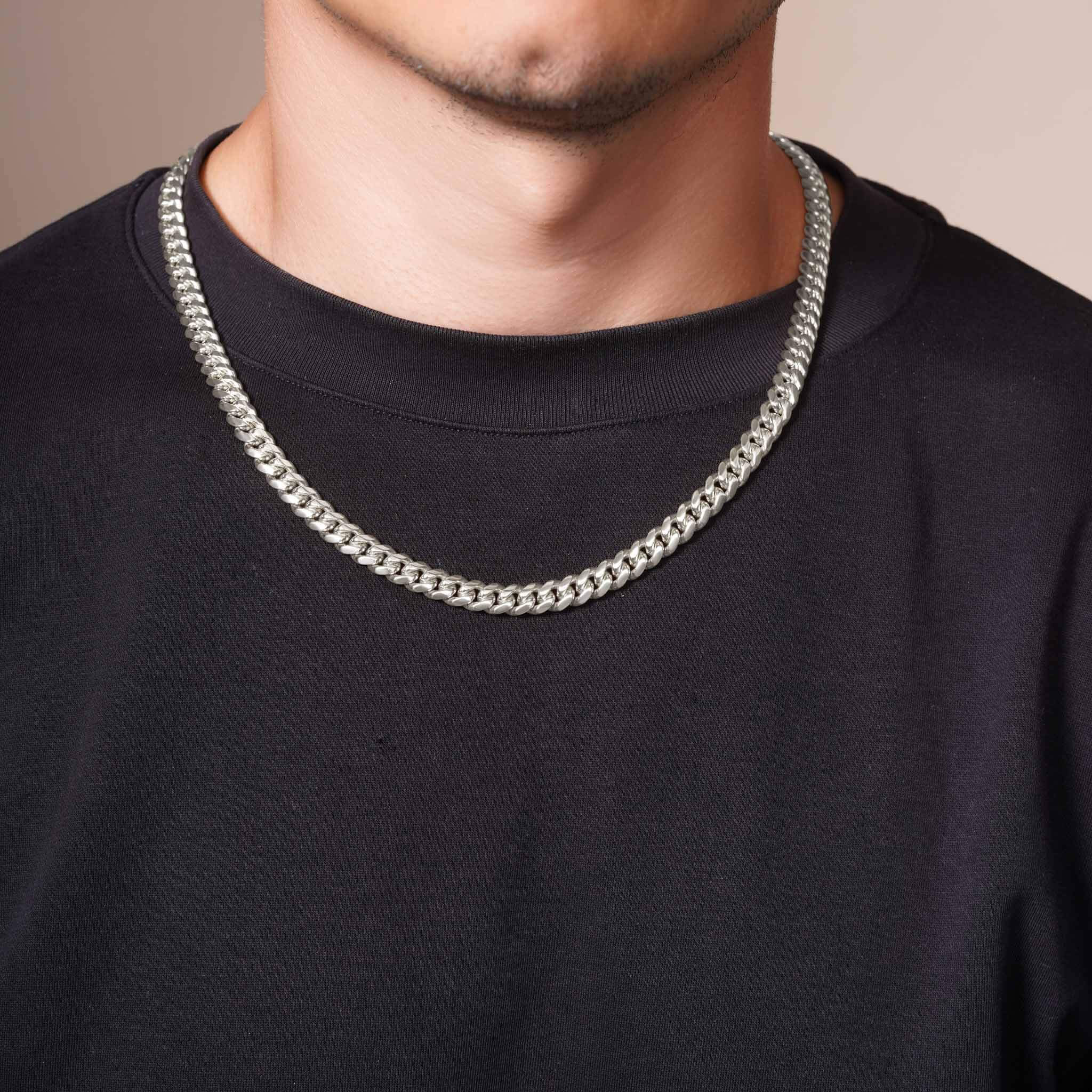 Men's Silver Miami Cuban Chain worn by a man, showcasing its sleek silver finish and classic design.