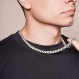 Men's Silver Miami Cuban Chain stylishly worn by a man, showcasing its polished silver finish and tight interlocked links.