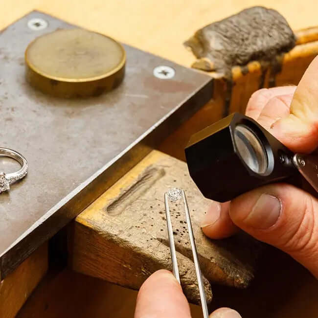 Jeweler examining a lab grown diamond with a loupe