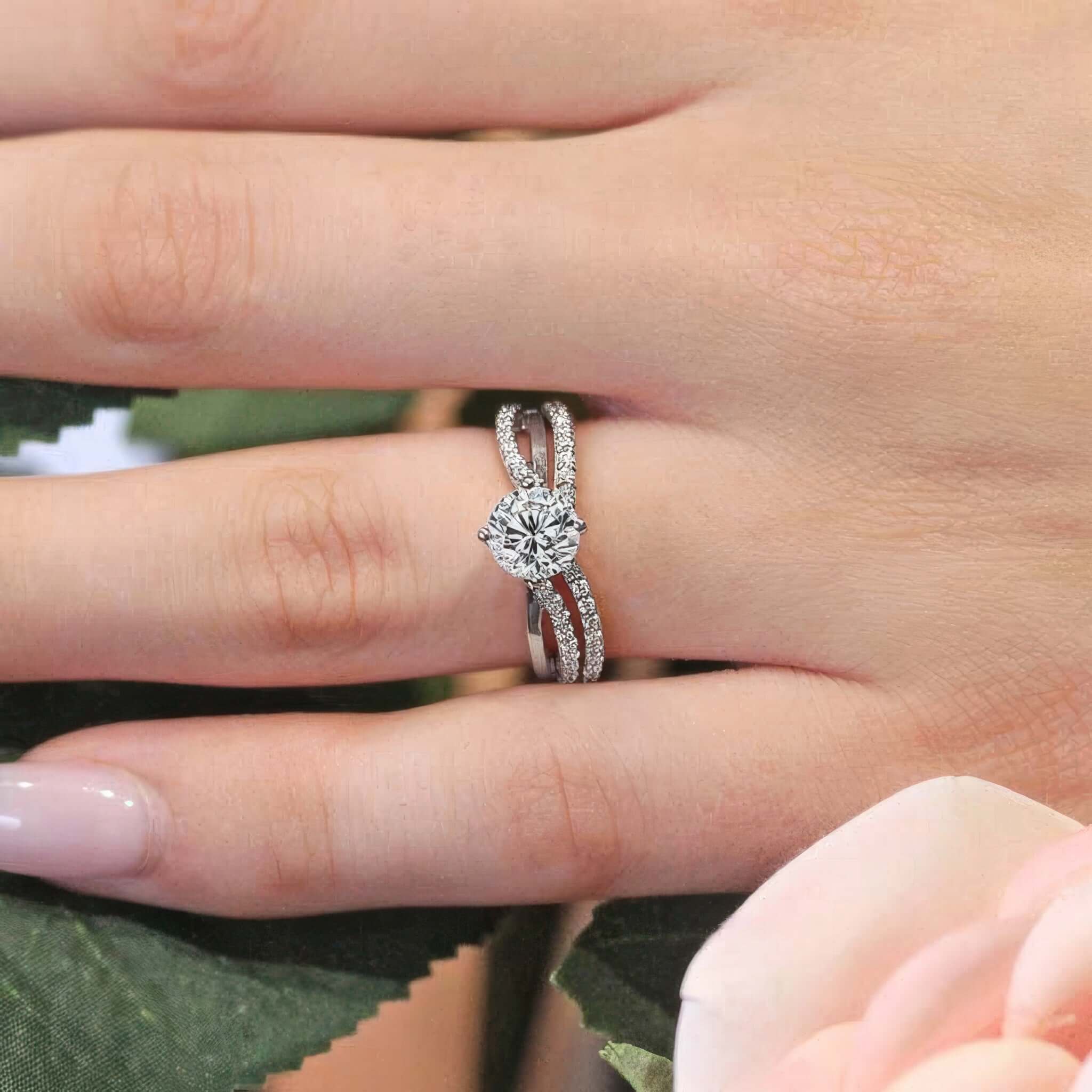 Lab grown diamond being showcased on a close up image of a twisted bridal set being worn on a hand. SKU: 8077S