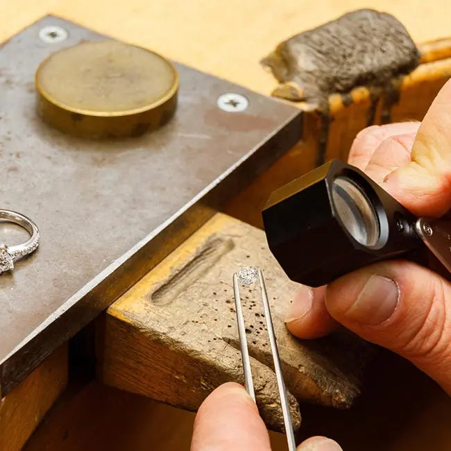 Jeweler examining a lab grown diamond with a loupe