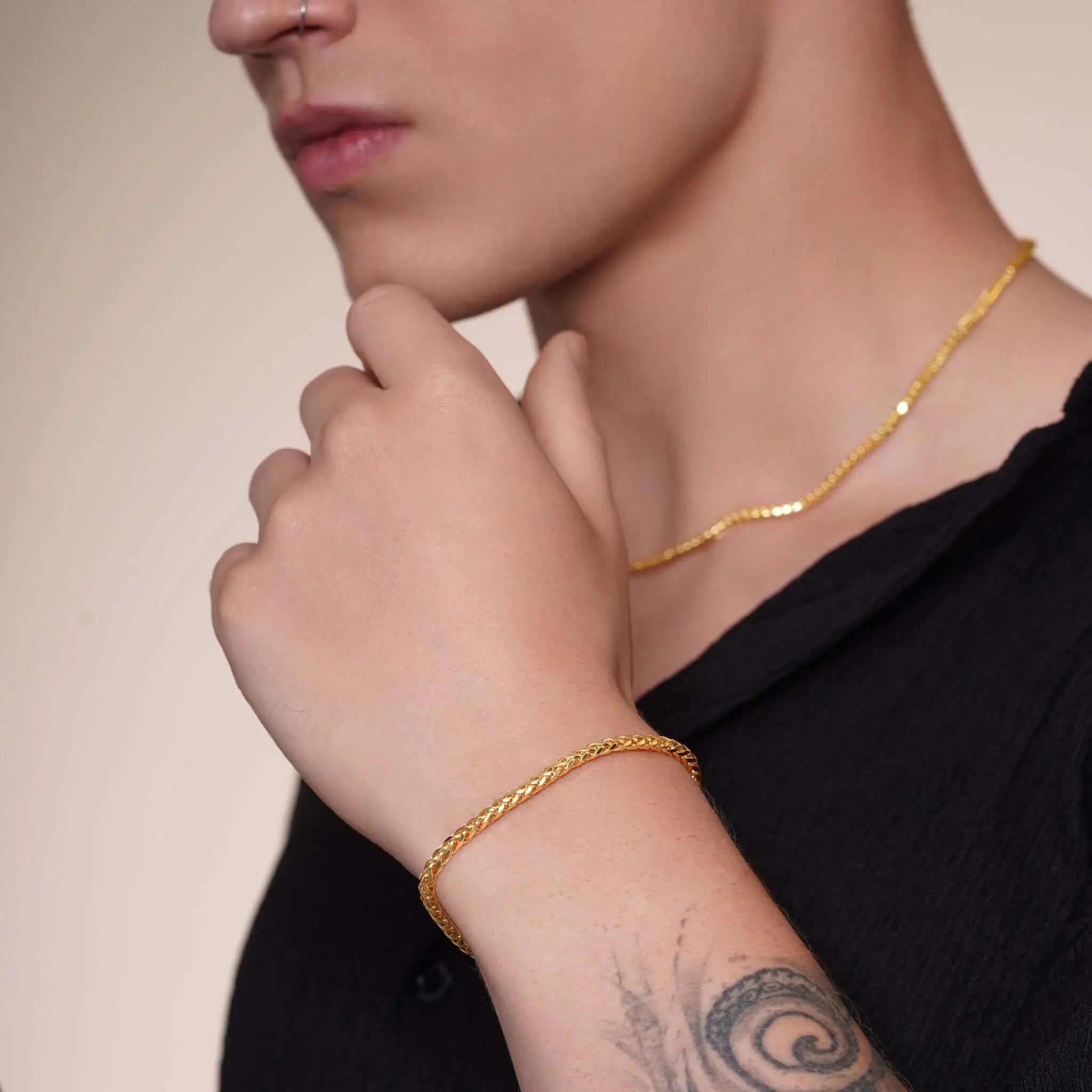Close-up of a man wearing gold chains and bracelets from the Gifts for Him collection, showcasing style and confidence.