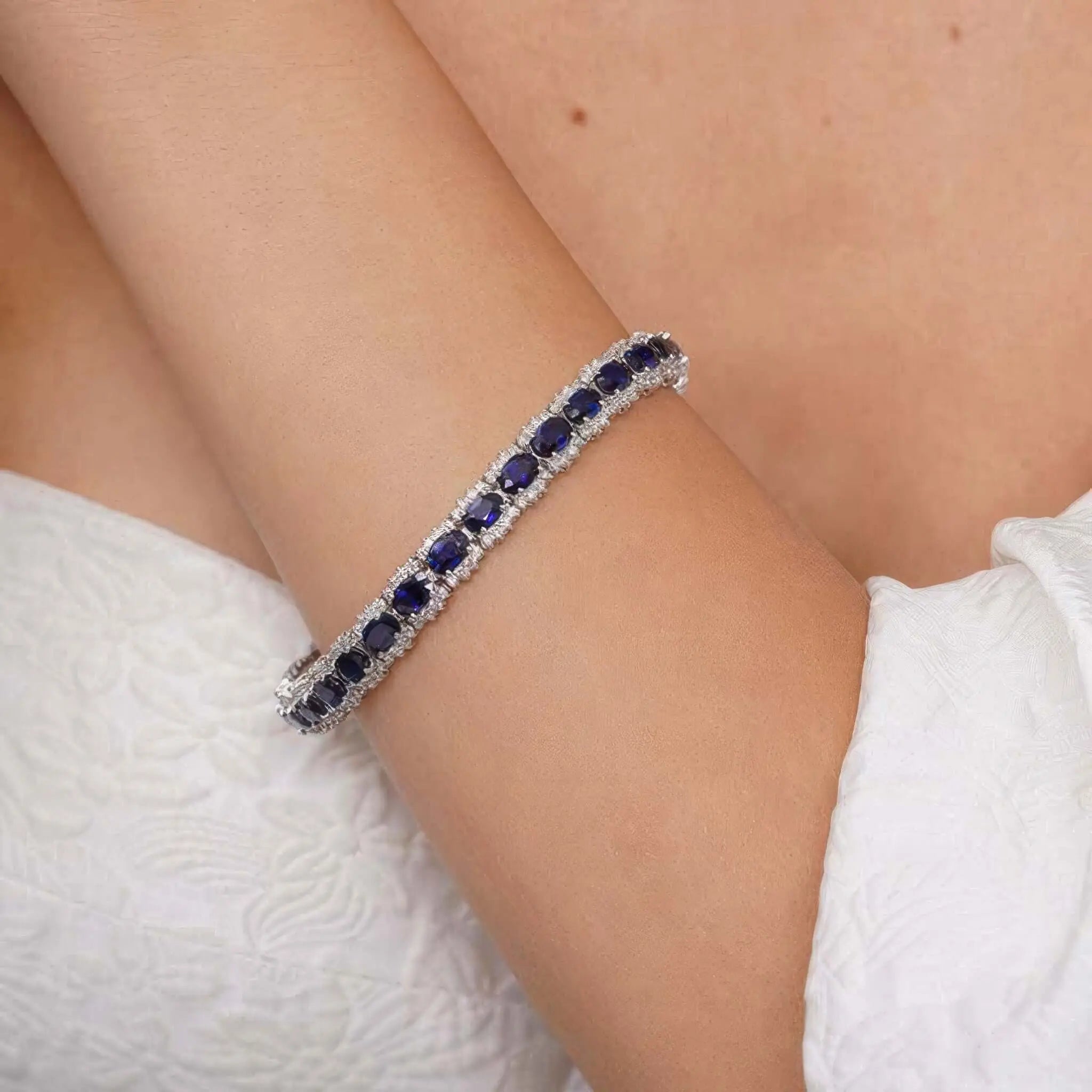 Elegant sapphire gemstone bracelet shimmering on the wrist, enhancing the beauty and charm of the wearer.
