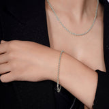 Silver Rolo Bracelet worn on a woman's wrist showcasing timeless interlocking circular links.