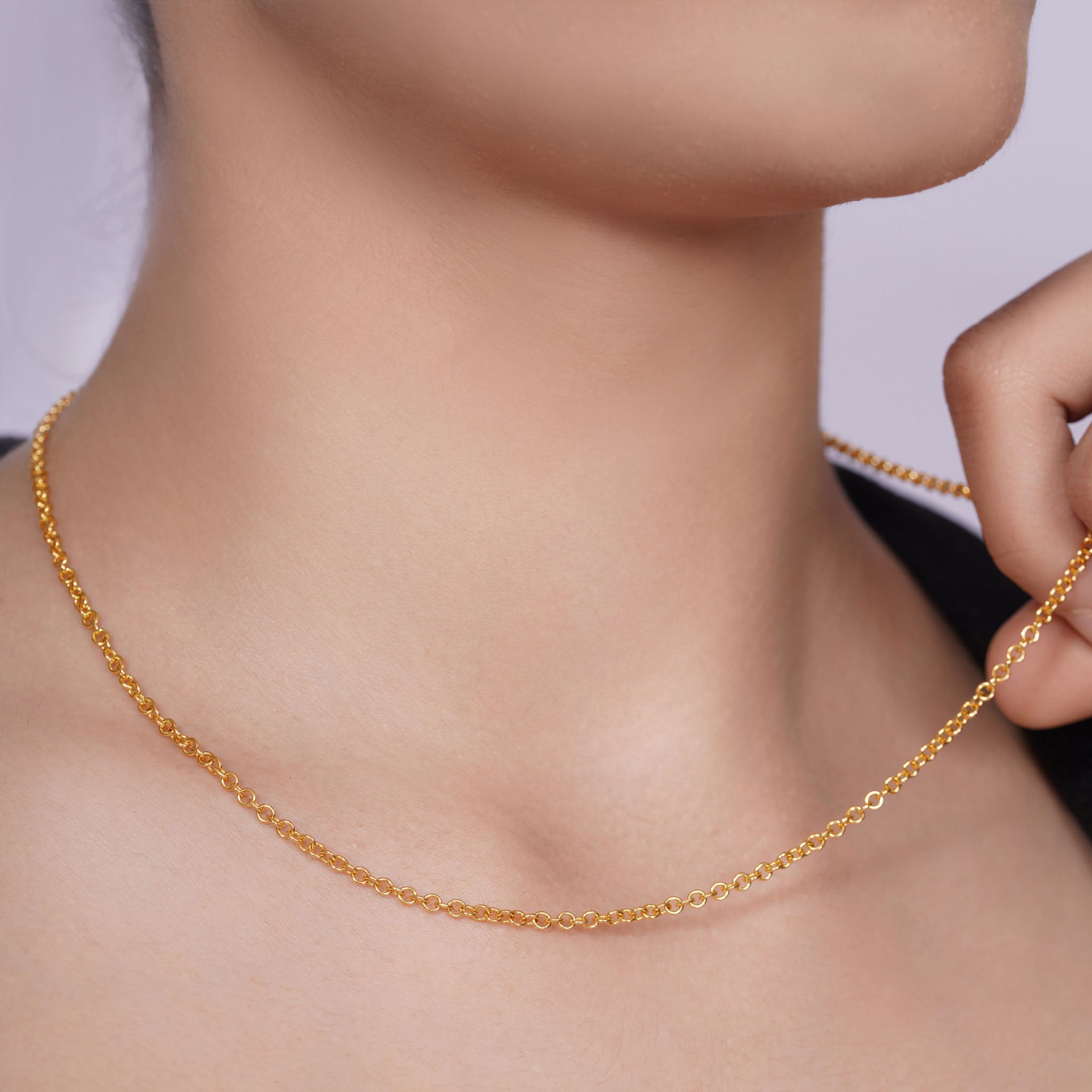 Vermeil Gold Rolo Chain elegantly displayed around a woman's neck, showcasing its lustrous gold plating and refined design.
