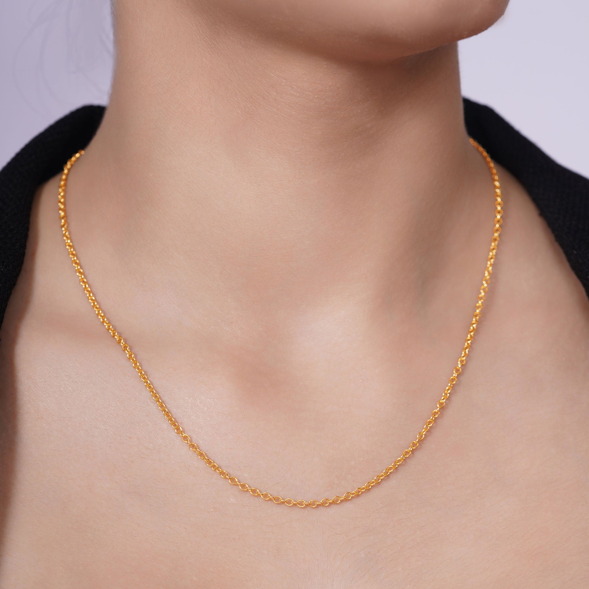 Vermeil Gold Rolo Chain elegantly worn on the neck, showcasing its timeless design and lustrous gold appeal.