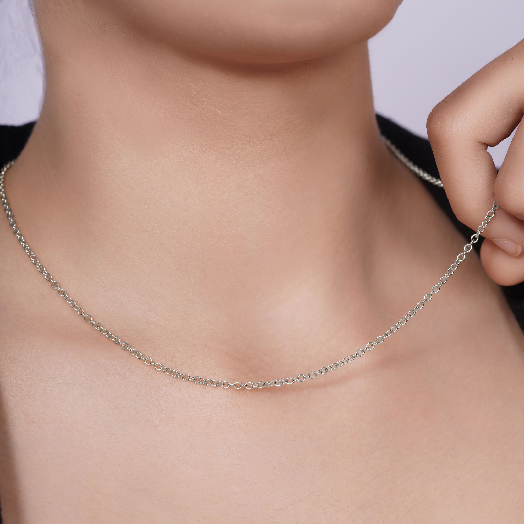Close-up of a Silver Rolo Chain necklace being modeled, highlighting its polished finish and elegant design.