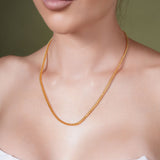 Diamond Cut Franco Vermeil Gold Chain elegantly displayed on a model's neck, showcasing its shimmering beauty.