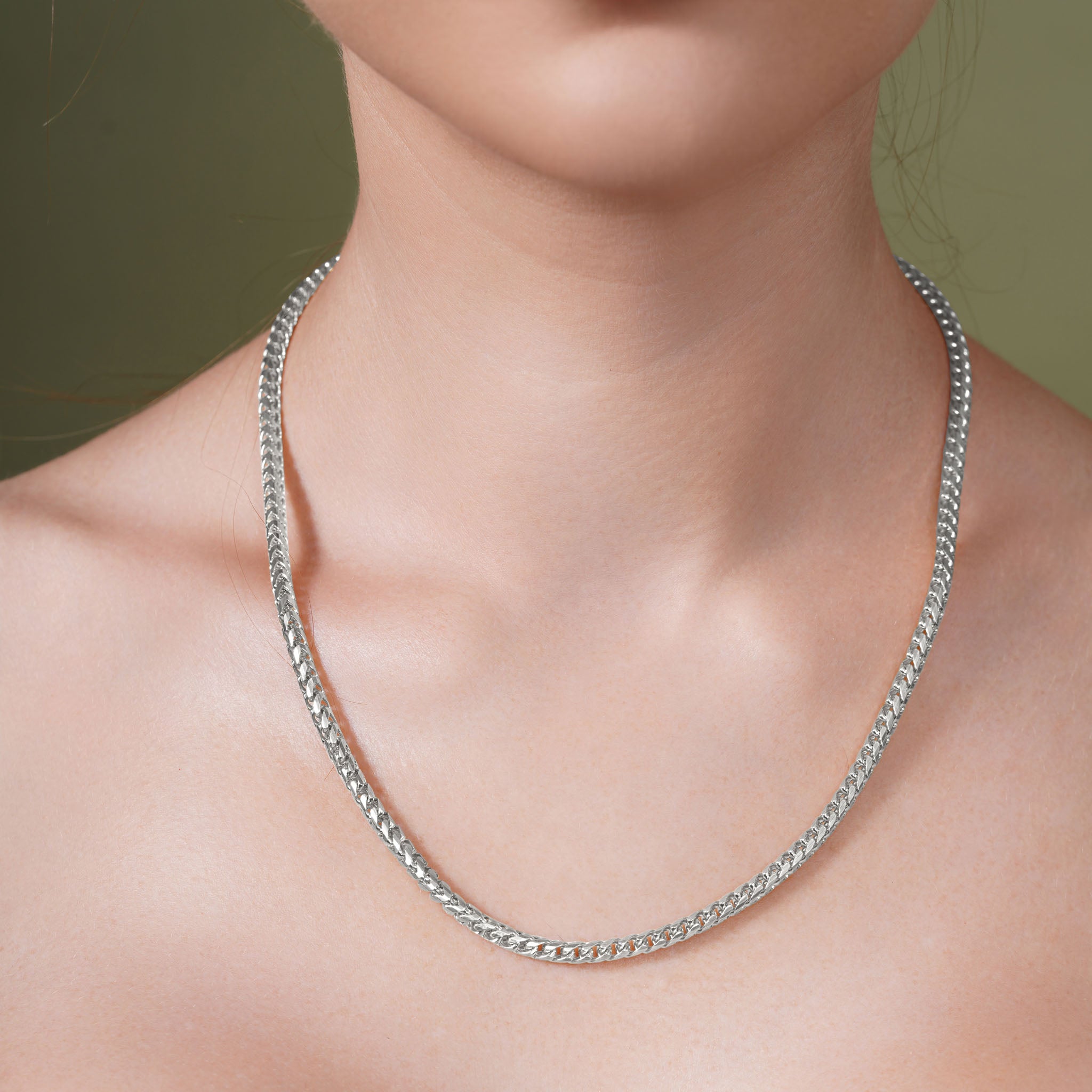Diamond Cut Franco Silver Chain worn on a model's neck, showcasing its sparkle and elegant design.