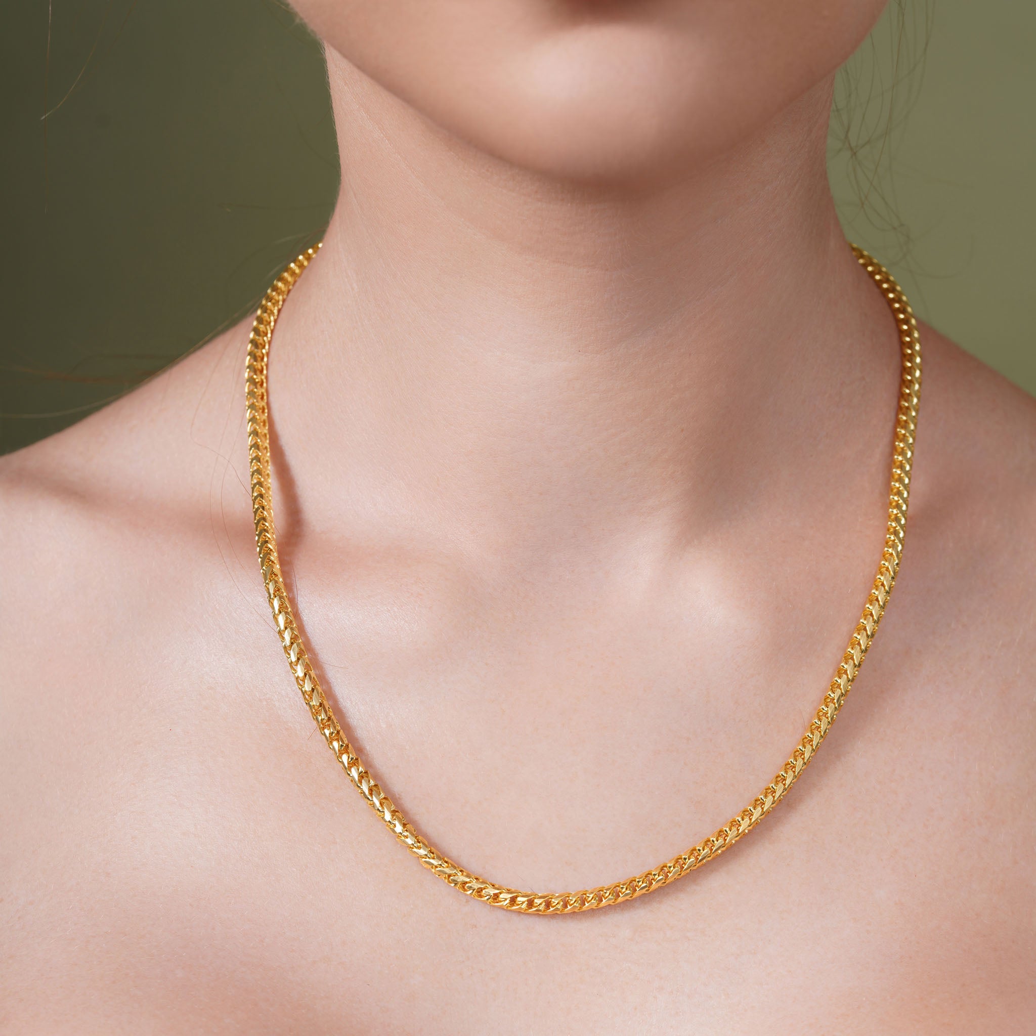 Diamond Cut Franco Vermeil Gold Chain elegantly displayed on a model's neck, showcasing its intricate design and sparkle.