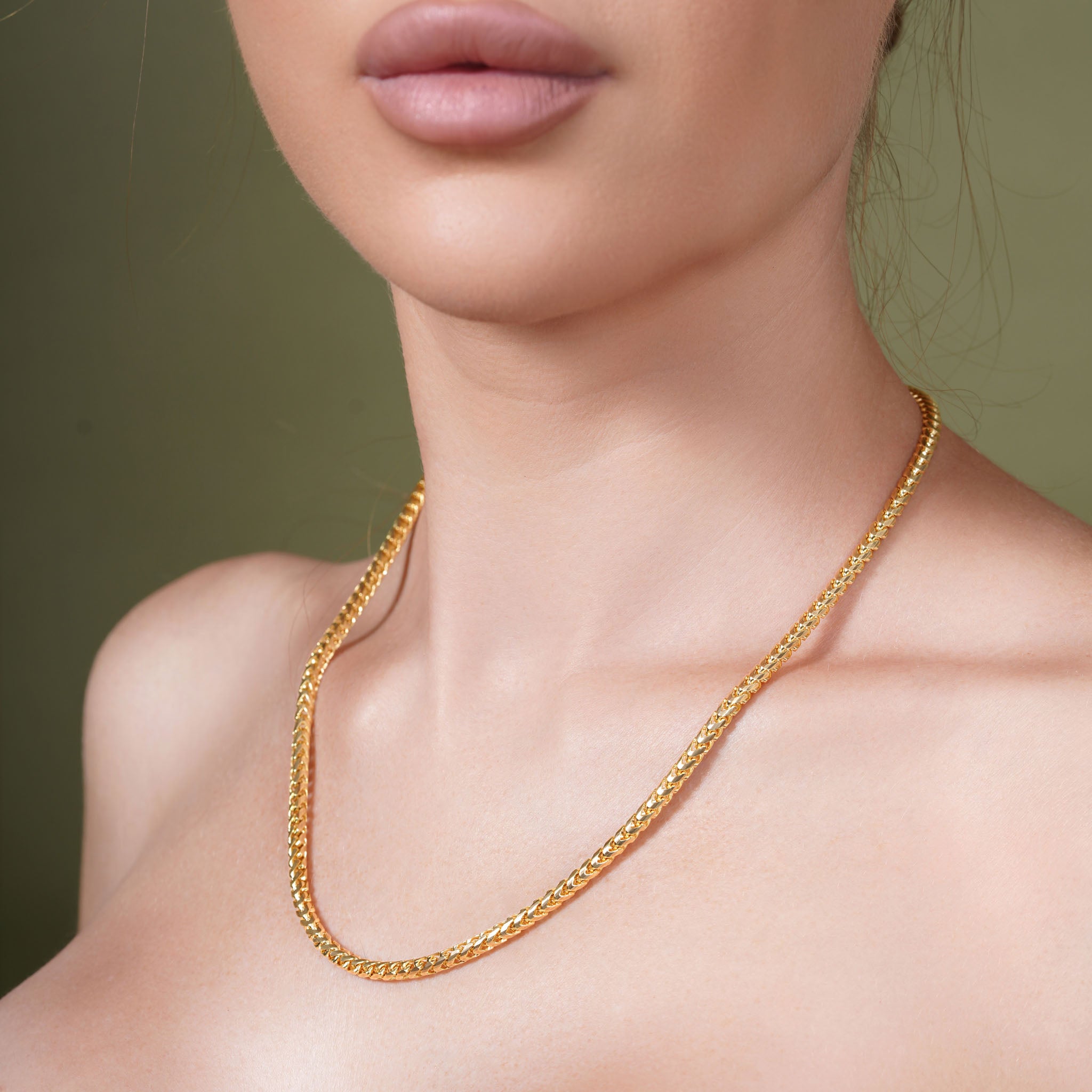 Diamond Cut Franco Vermeil Gold Chain displayed on a model's neck, highlighting its exquisite shine and intricate design.