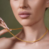 Model wearing Diamond Cut Franco Vermeil Gold Chain, showcasing its sparkle and elegance against a neutral background.