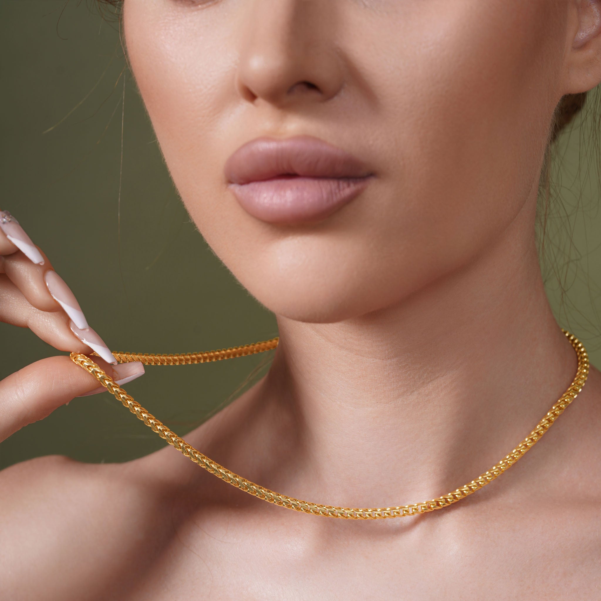 Model wearing Diamond Cut Franco Vermeil Gold Chain, showcasing its sparkle and elegance against a neutral background.