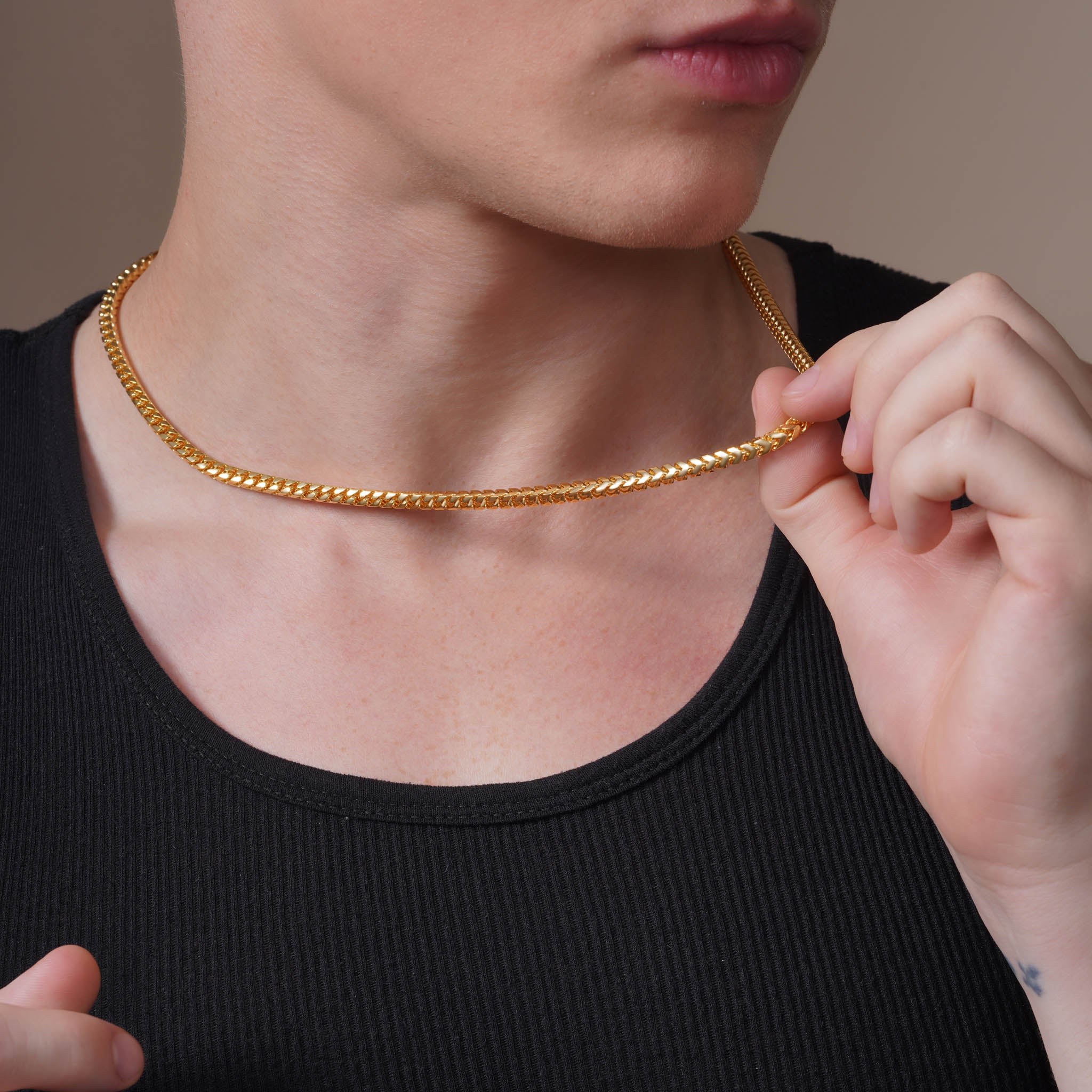 Men's Franco 18K Gold Vermeil Chain worn by a man, showcasing its luxurious gold finish and interlocking links.