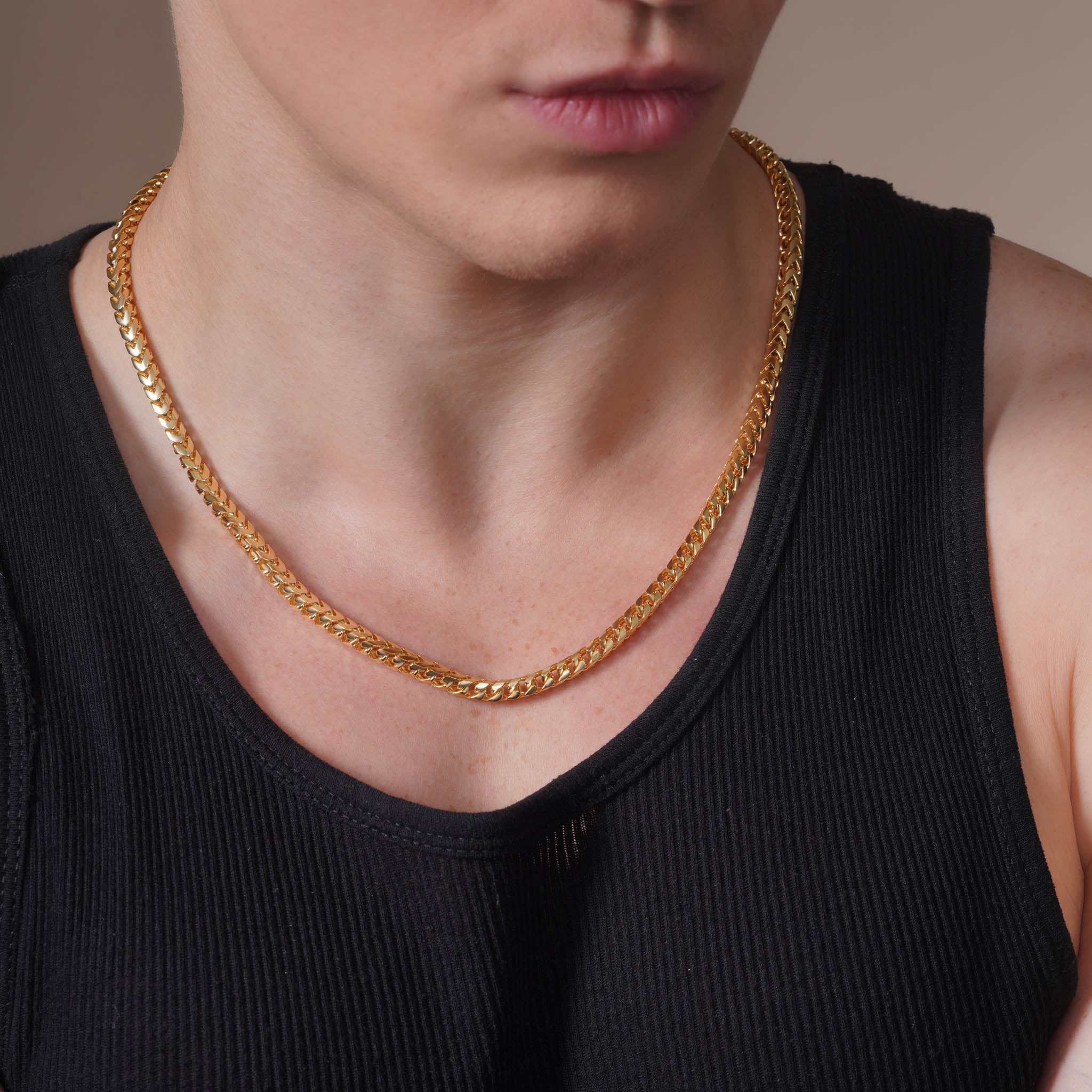 Men's Franco 18K Gold Vermeil Chain worn by a gentleman, showcasing its interlocking links and luxurious gold finish.