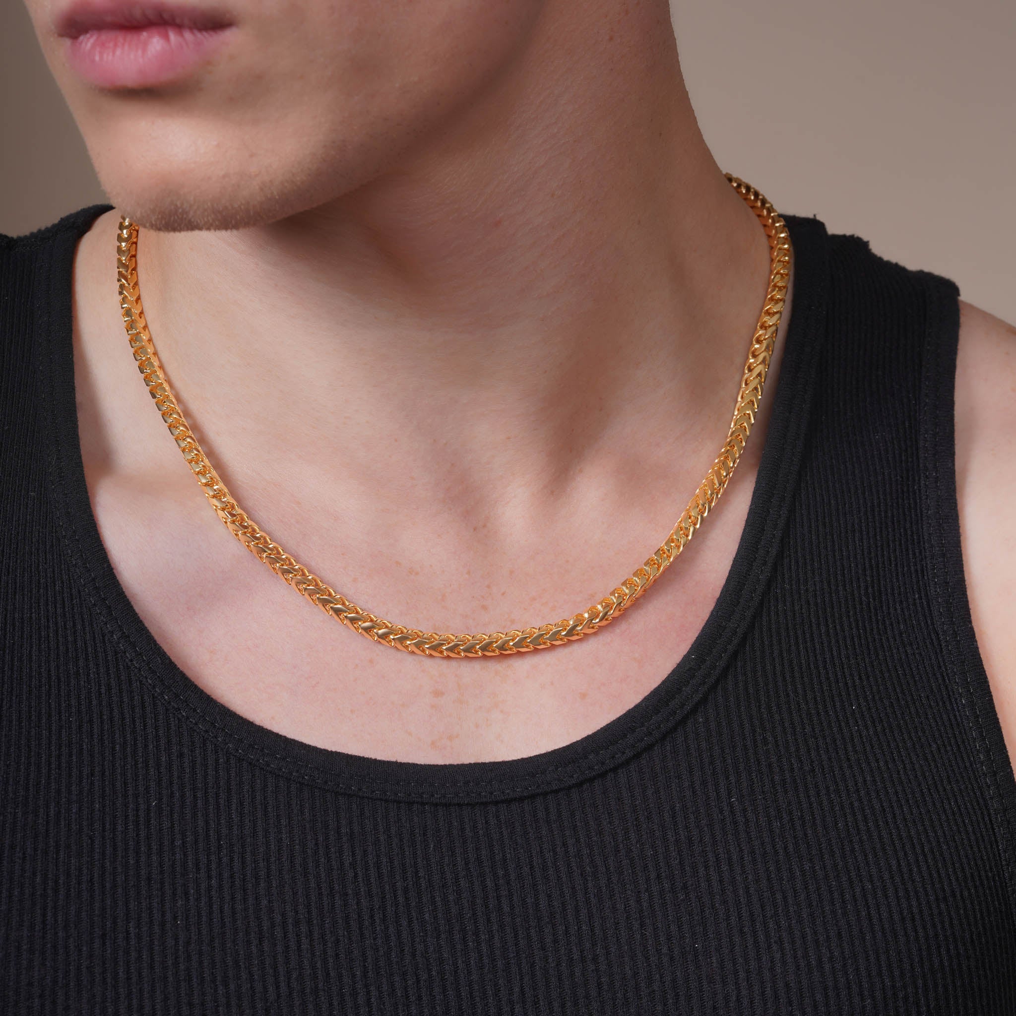 Close-up of a man wearing a Men's Franco 18K Gold Vermeil Chain against a simple background.