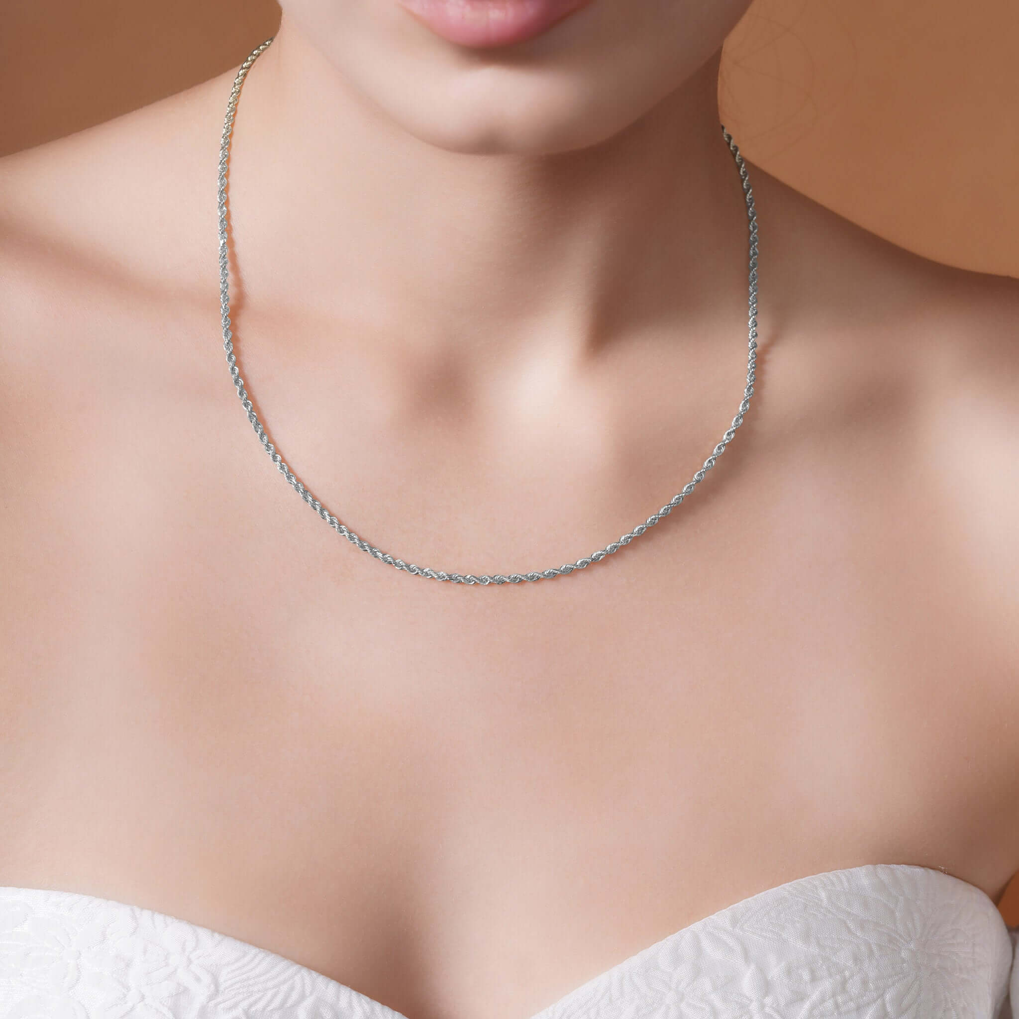 Sterling Silver Rope Chain Necklace worn on a model's neck, showcasing its shine and texture.