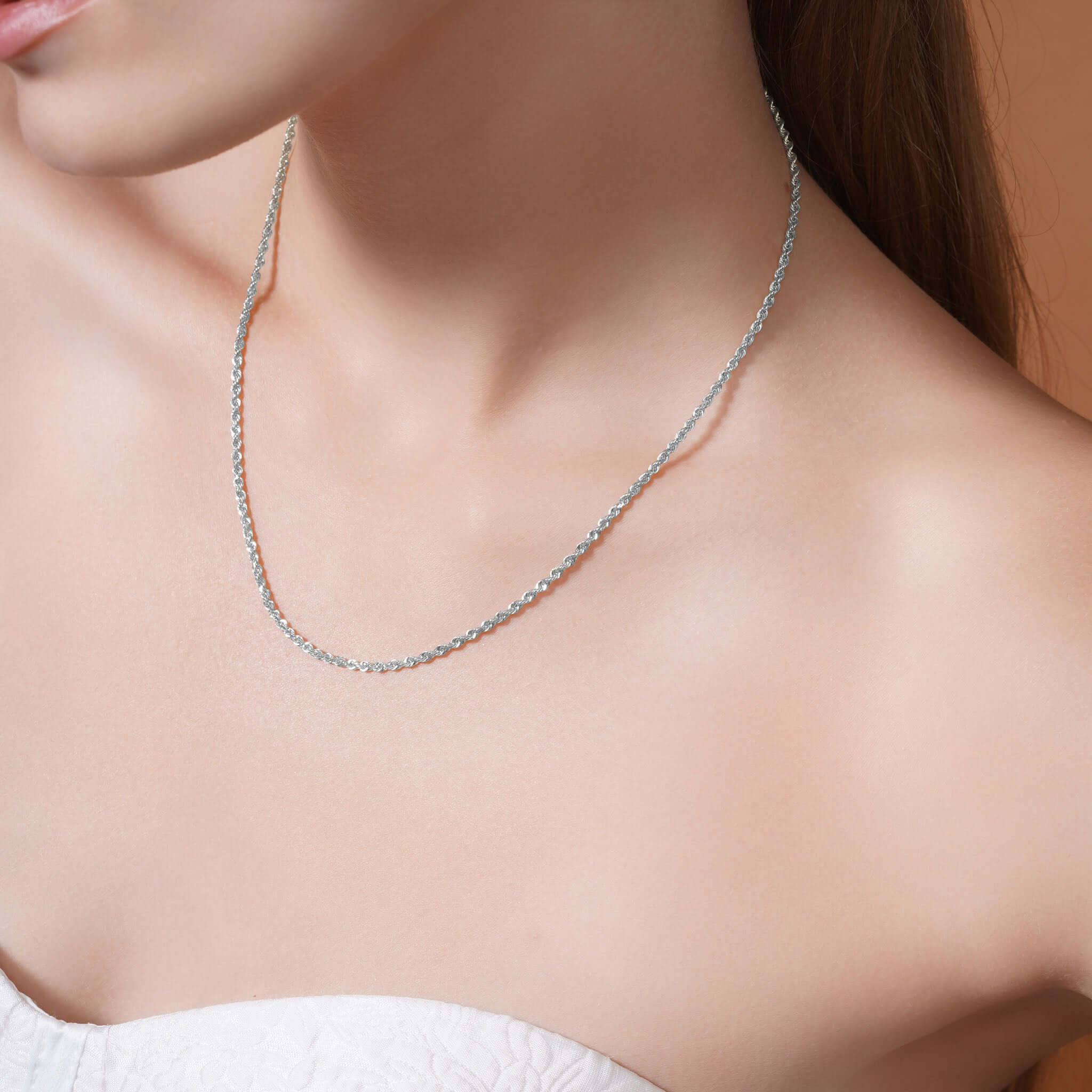 Sterling Silver Rope Chain Necklace worn on a model's neck showing its shine and texture.