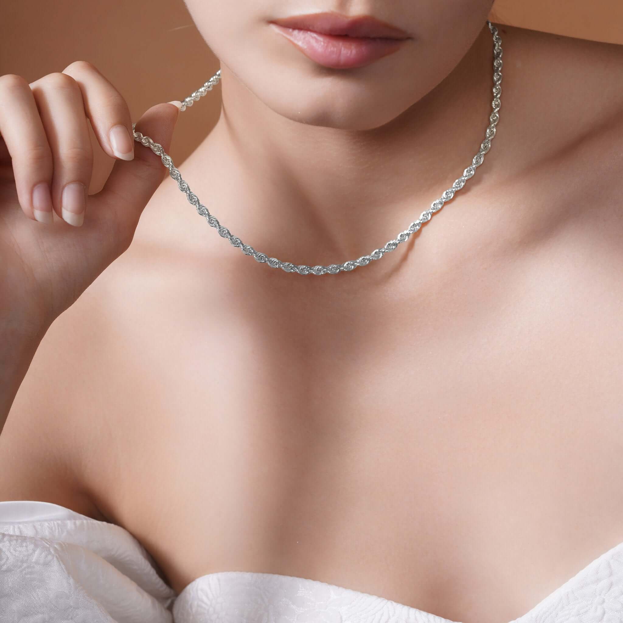 Sterling Silver Rope Chain Necklace worn by a model, showcasing its shine and texture against a soft background.
