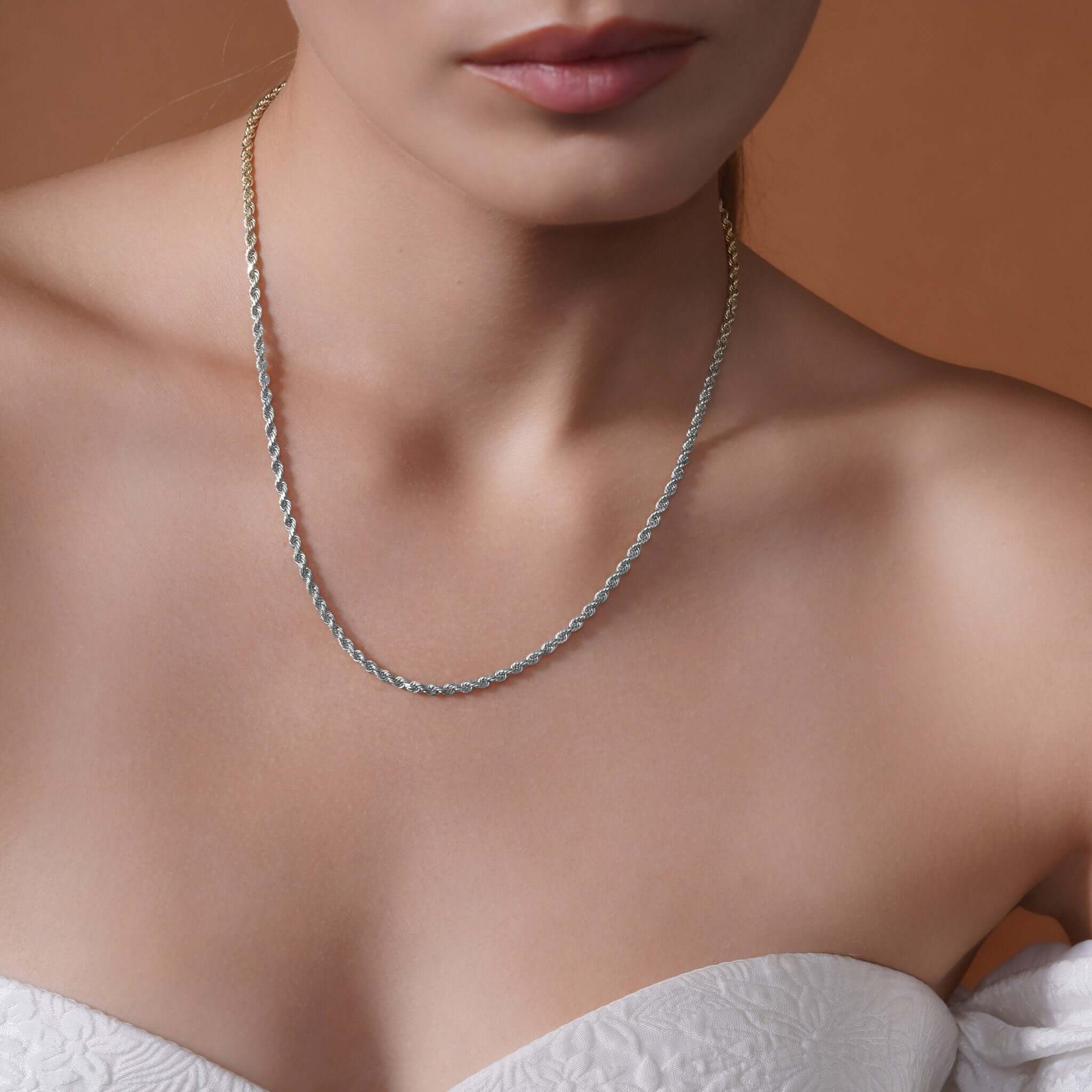Model wearing a Sterling Silver Rope Chain Necklace, showcasing its texture and shine against a neutral background.