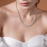 Close-up of a woman wearing a Sterling Silver Rope Chain Necklace showcasing its texture and shine.