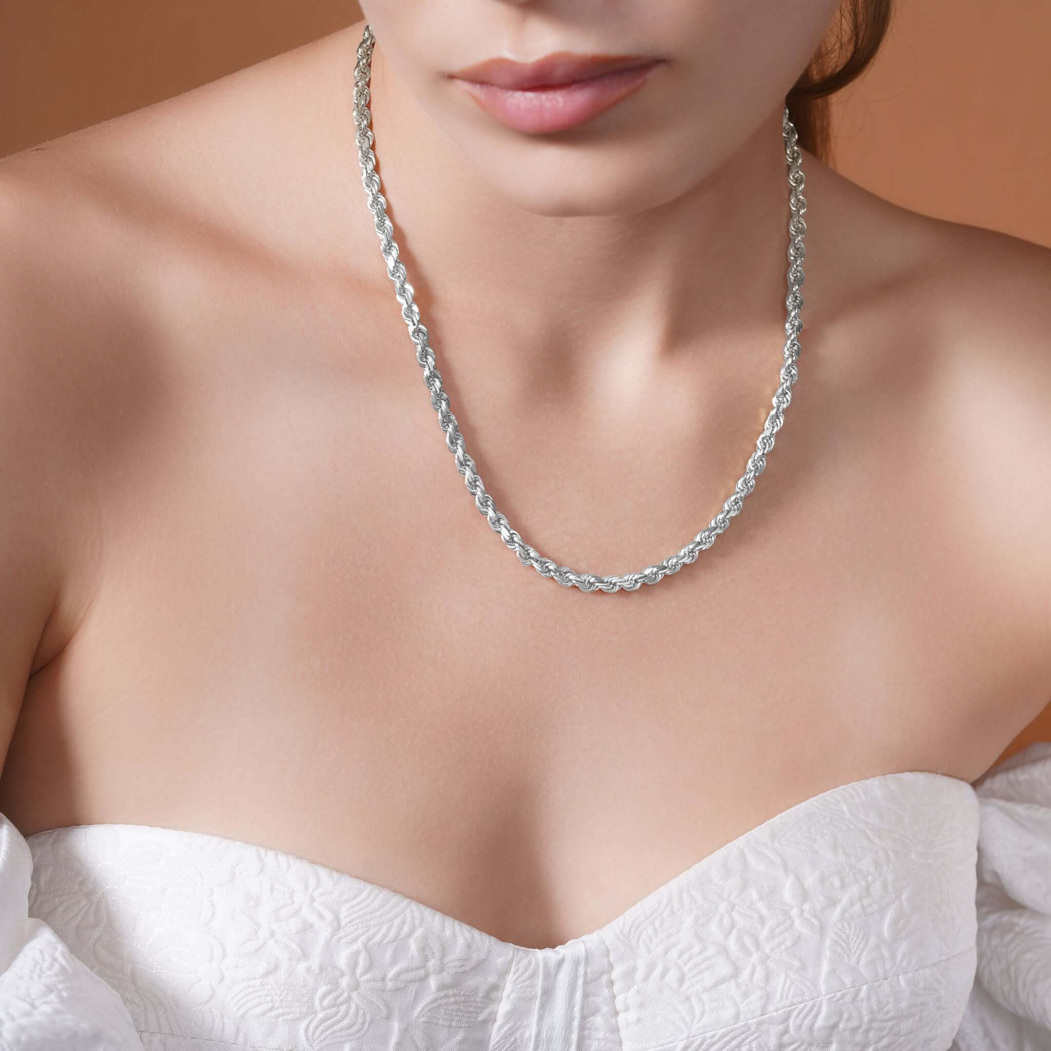 Close-up of a woman wearing a Sterling Silver Rope Chain Necklace showcasing its texture and shine.