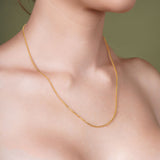 18K Gold Vermeil Franco Chain displayed on a model's neck, showcasing luxury and elegance.