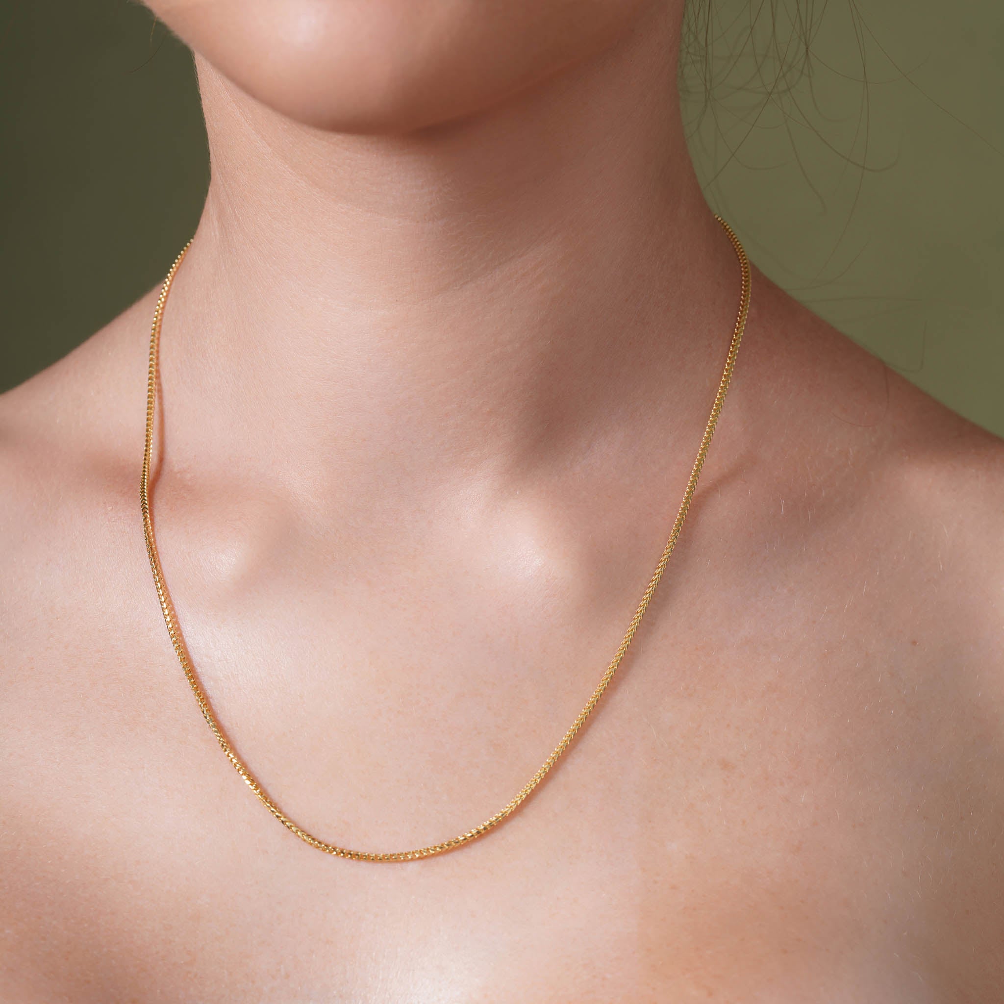 18K Gold Vermeil Franco Chain worn elegantly on a model's neck, showcasing its luxurious design.