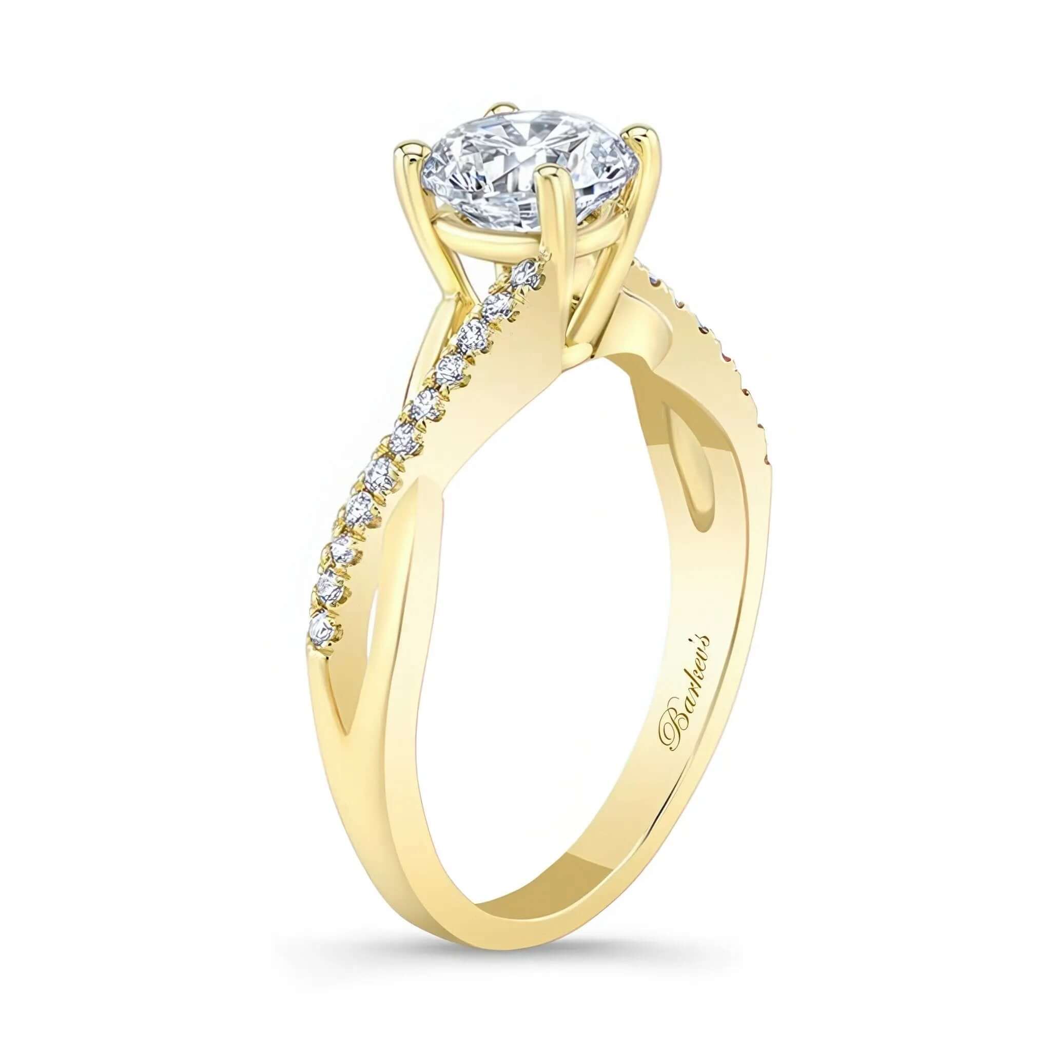 Simple Diamond Ring featuring a prong set round center and intertwining shoulders with diamond melees