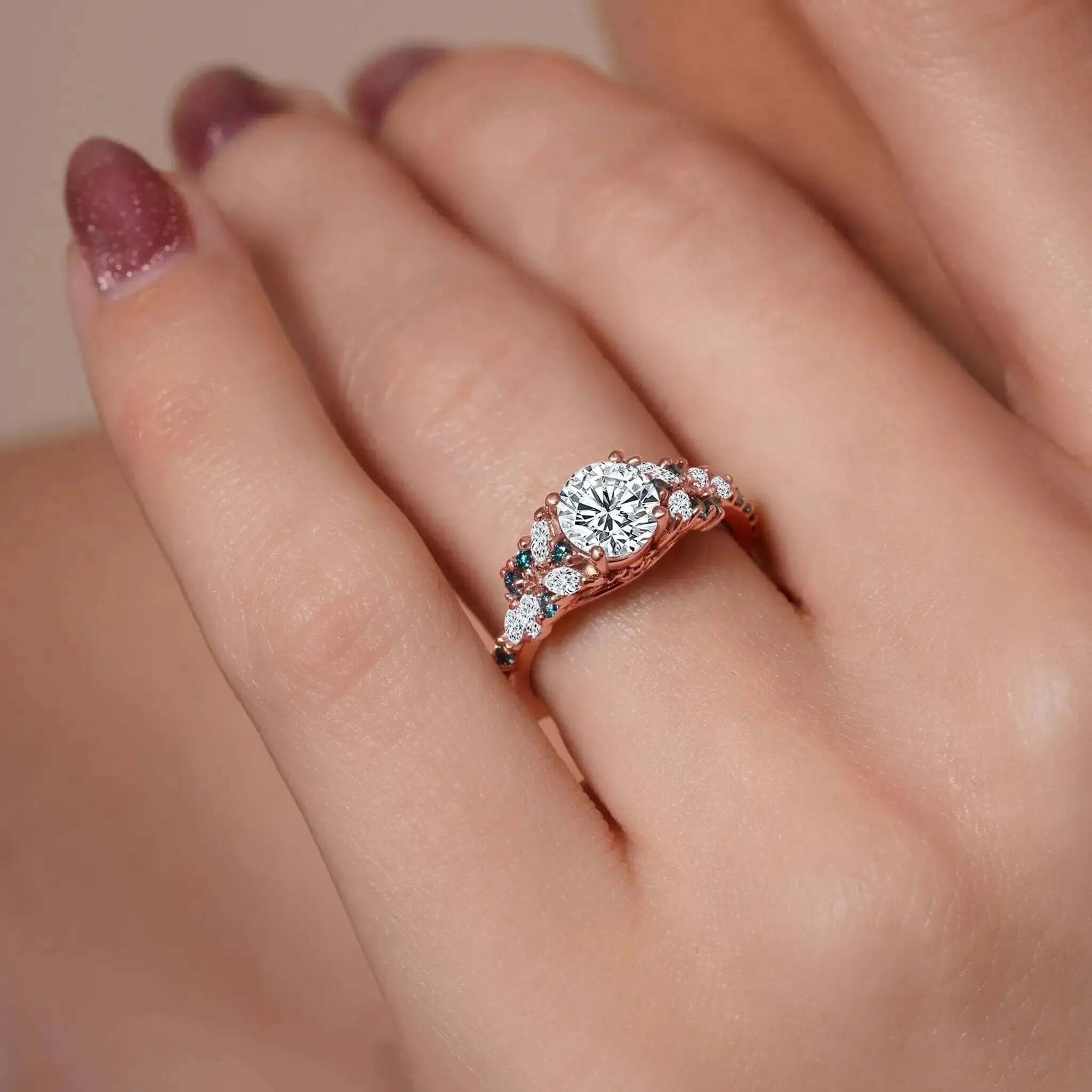 Vintage Marquise Blue Diamond Accent Engagement Ring showcased on a hand with elegant nail polish, featuring a round center and blue accents.