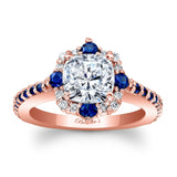 Rose gold ring with a diamond and blue gemstones on a white background