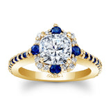 Gold ring with a diamond and blue gemstones on a white background