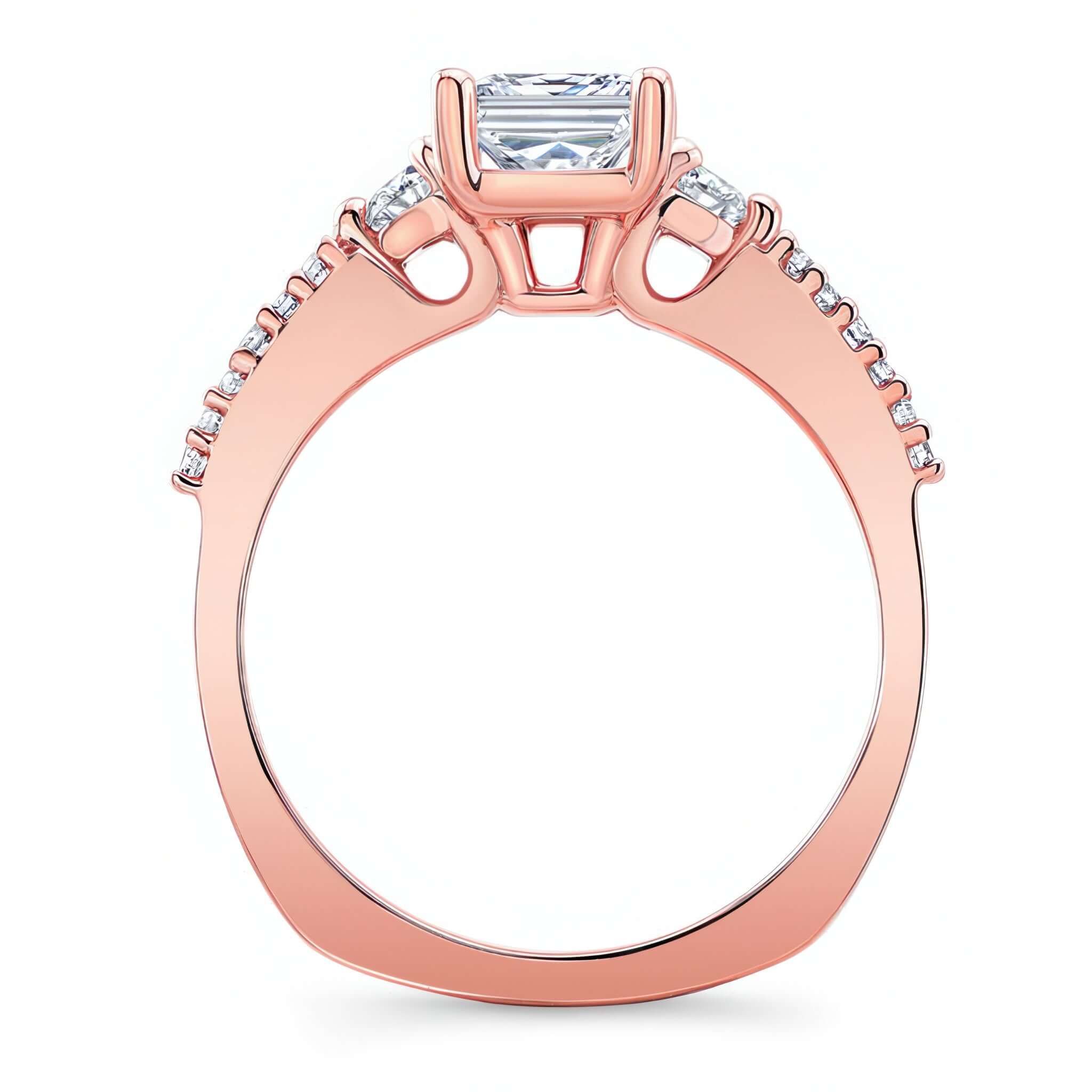 3 Stone Emerald Cut Engagement Ring with a prong-set diamond center and diamond accents in rose gold.
