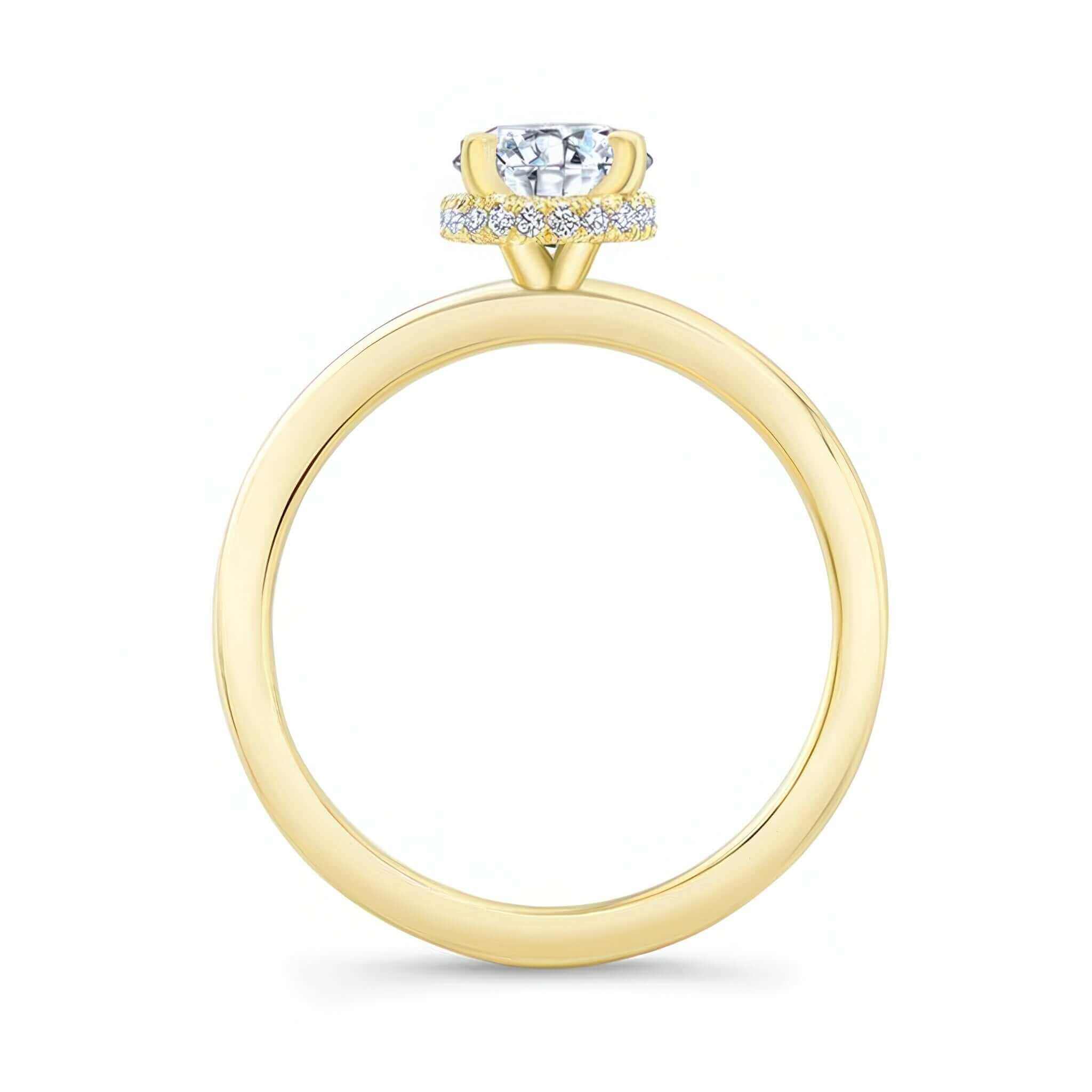 Oval Moissanite Engagement Ring with hidden diamond halo and a 1.25 carat center stone in a yellow gold setting.