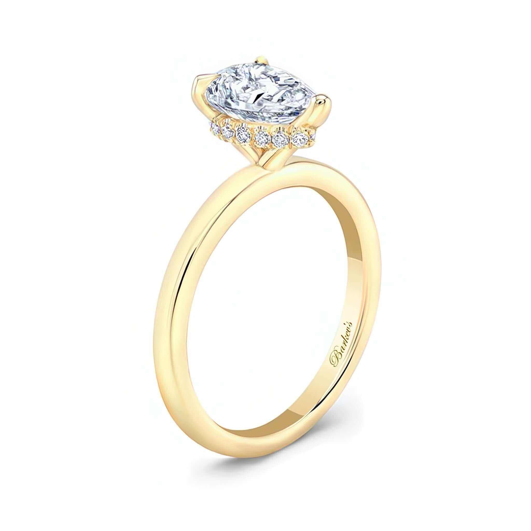 Hidden Halo Pear Engagement Ring showcasing a prong set pear shape center and micro pave halo for elegance.