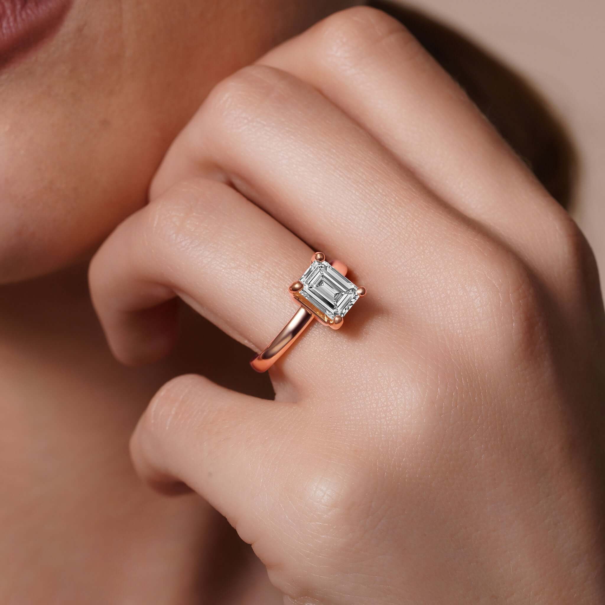 Emerald Cut Lab Grown Diamond Solitaire Engagement Ring worn on model's hand, showcasing a stunning 2.00ct center stone.