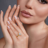 Close-up of a woman's hand showcasing a double band 2 carat emerald cut diamond solitaire ring.
