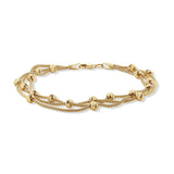 Gold bracelet with multiple chains and beads on a white background