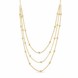 Gold necklace with multiple beaded strands on a white background