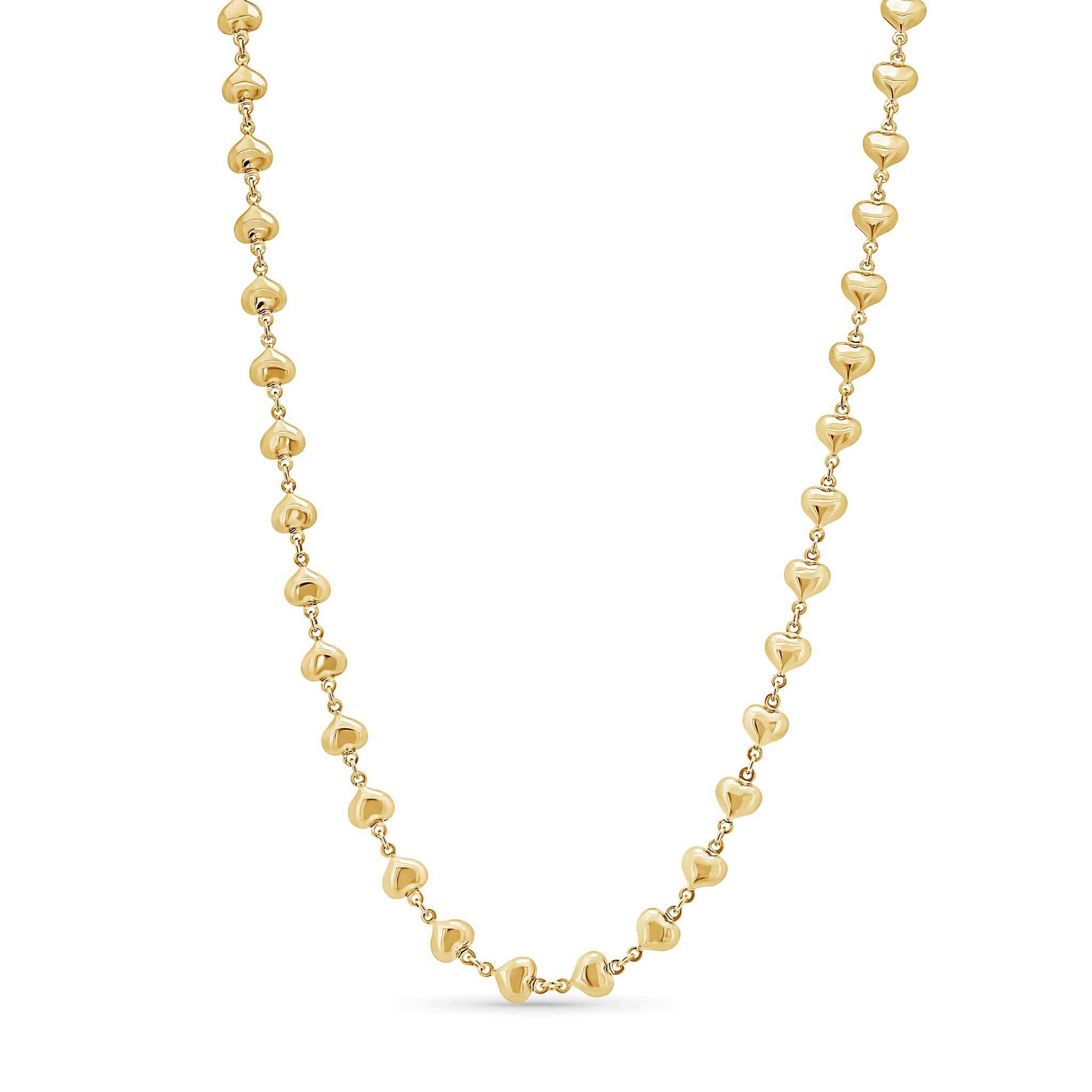 Gold heart shaped beaded necklace on a white background